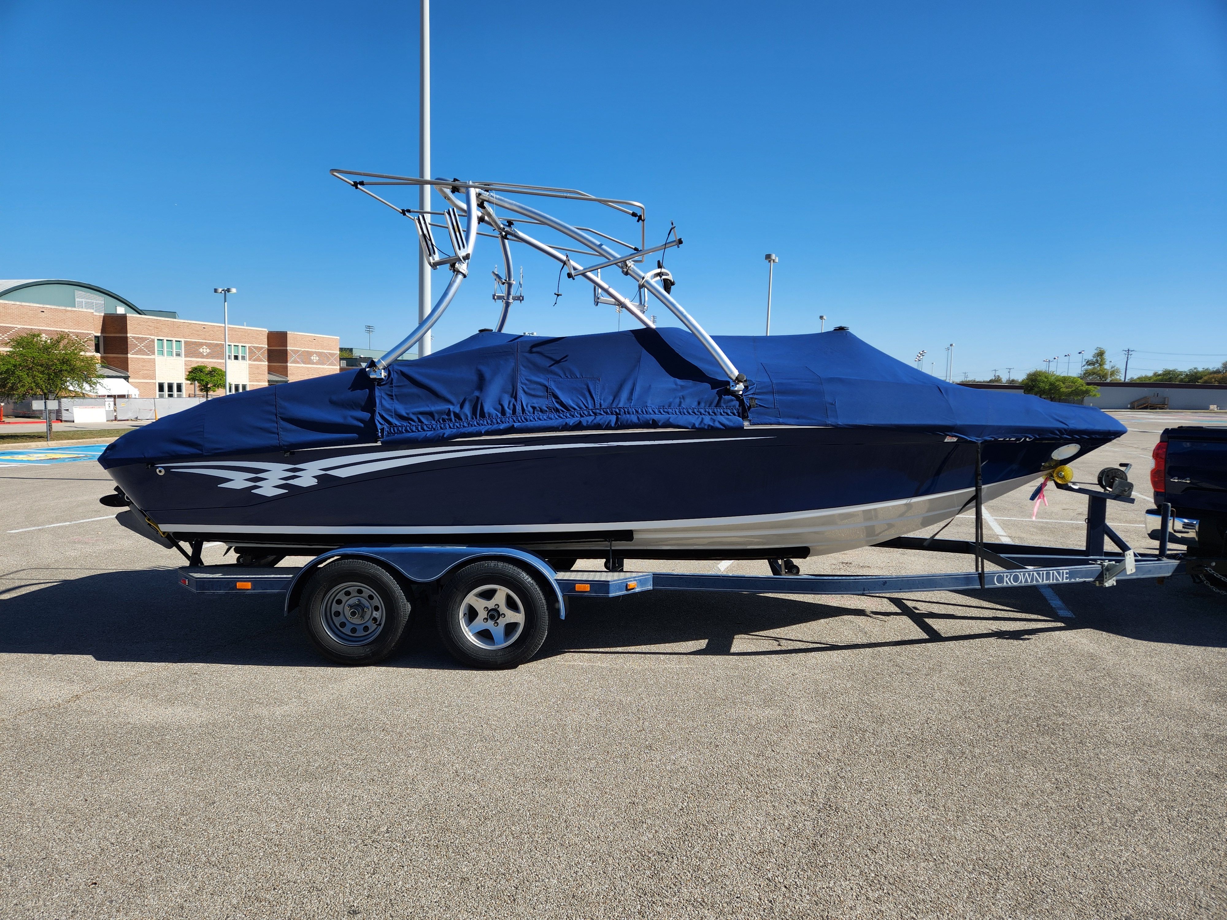 2003 Crownline 225 BR boat on trailer parked outdoors.
