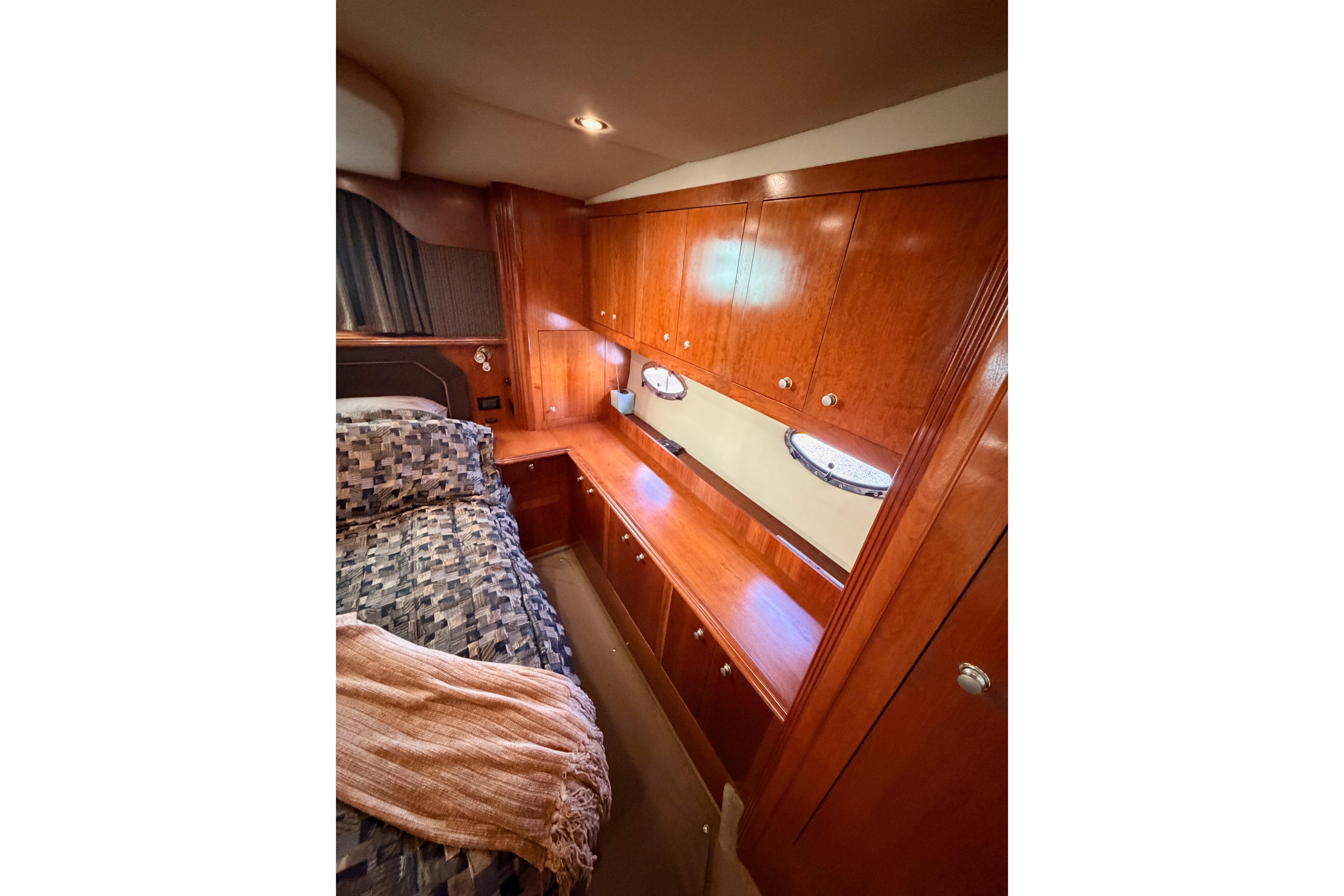 Luxurious cabin interior of 2005 Cruisers Yachts 405 Express Motoryacht with wood cabinetry.