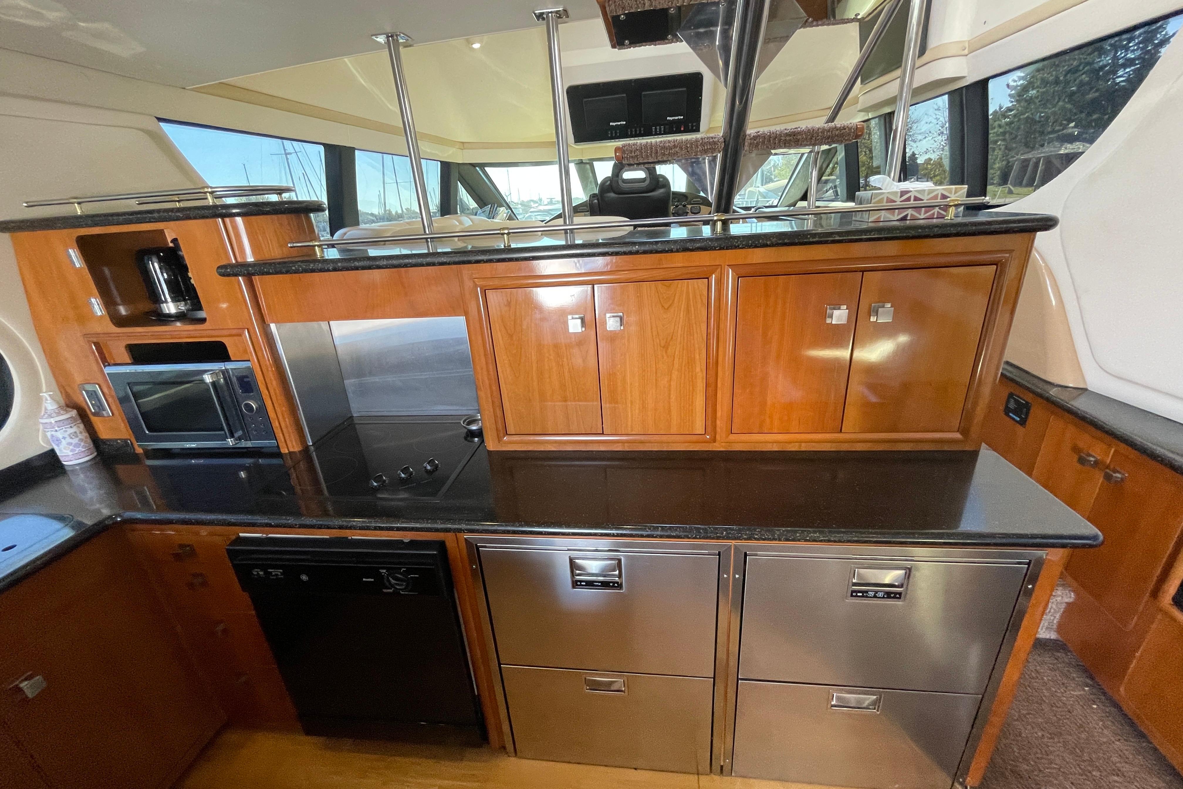 Luxurious kitchen interior of 2002 Carver 570 Voyager Pilothouse yacht with modern appliances.