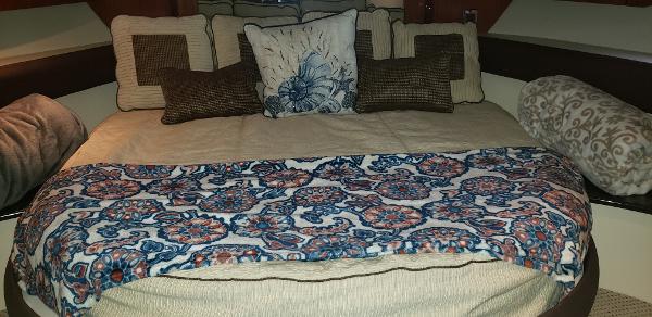Cozy bedroom in 2010 Meridian 441 Sedan with patterned bedding and decorative pillows.