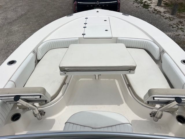 The image shows the bow of a 2015 Robalo 246 Cayman boat with white cushioned seating.