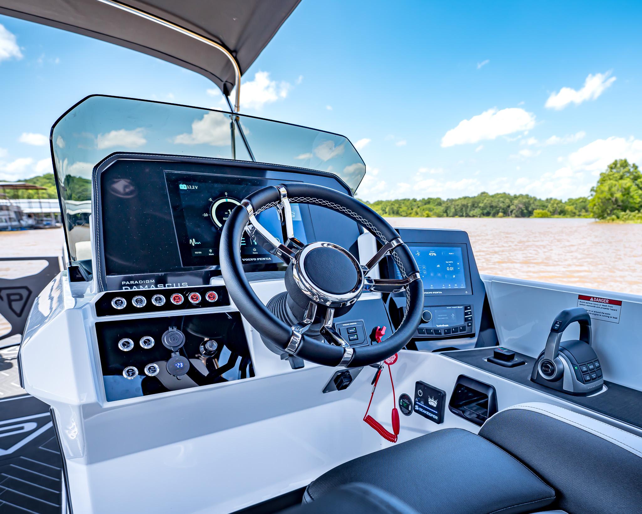 2025 Paradigm Damascus 266 Surf boat dashboard with modern controls and steering wheel.
