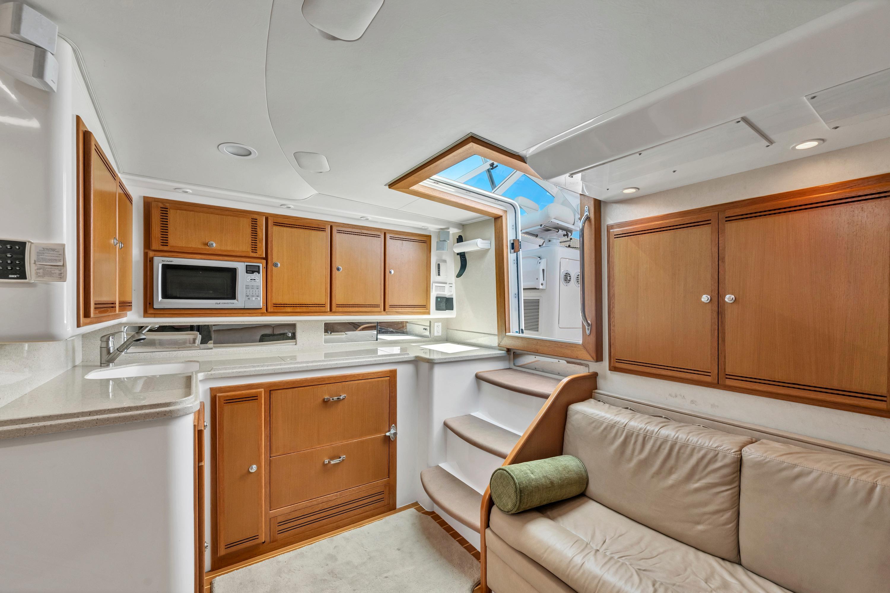 Luxurious 2010 Cabo 45 Express yacht interior with modern kitchen and comfortable seating.