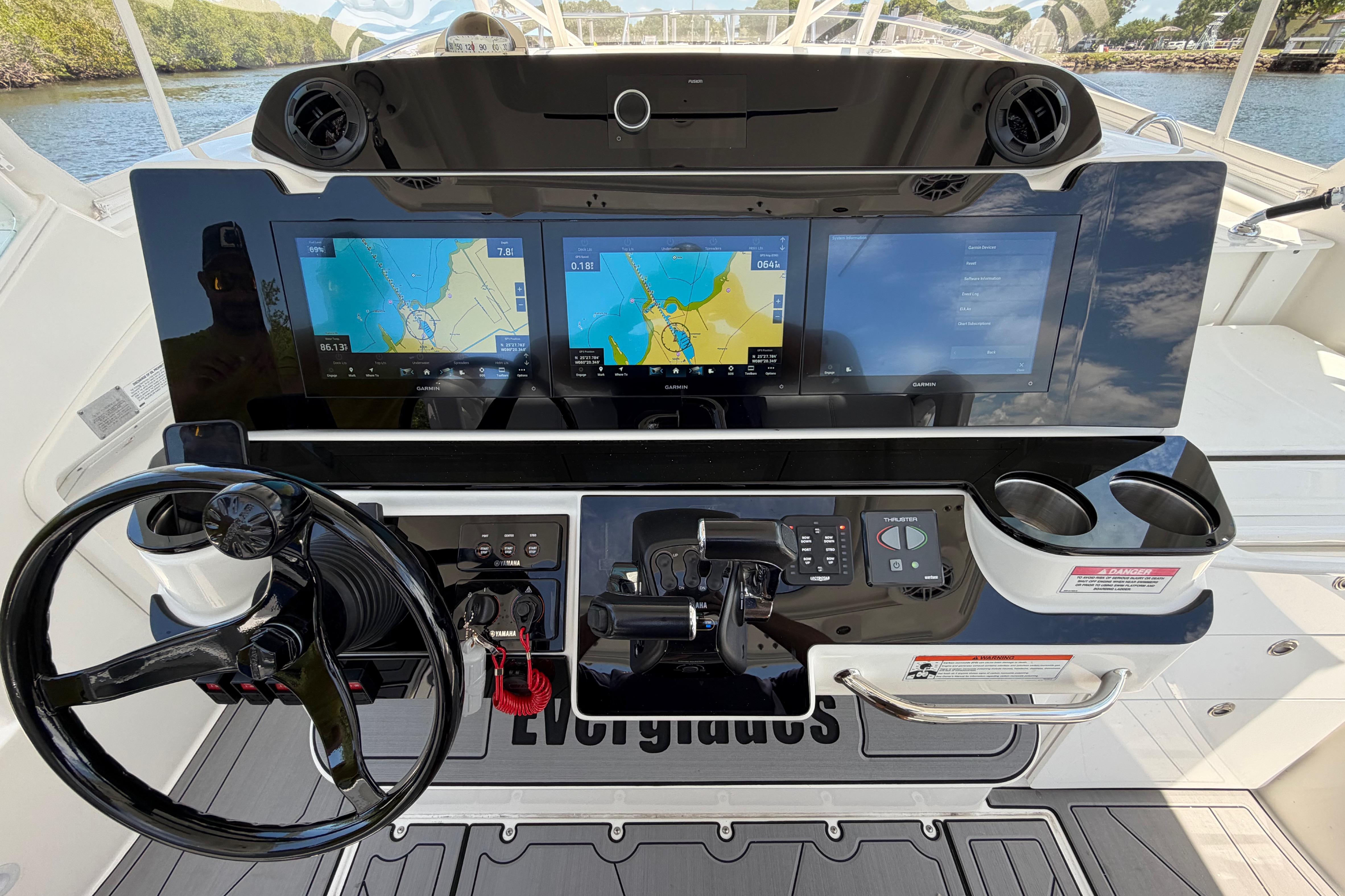 2009 Everglades 350LX boat dashboard with dual navigation screens and steering wheel.