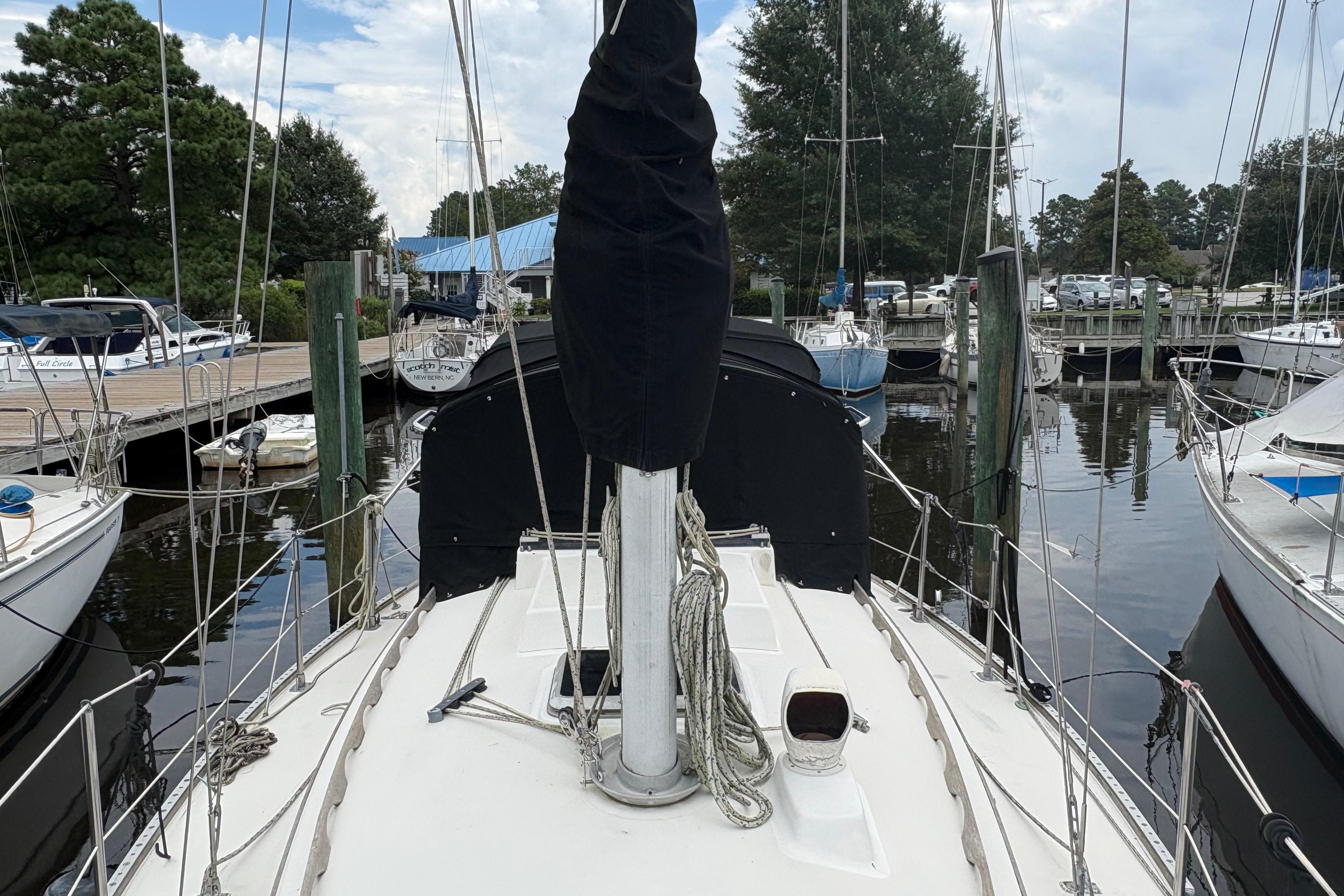 1981 Sabre 31 sailboat docked at a marina, surrounded by other boats.