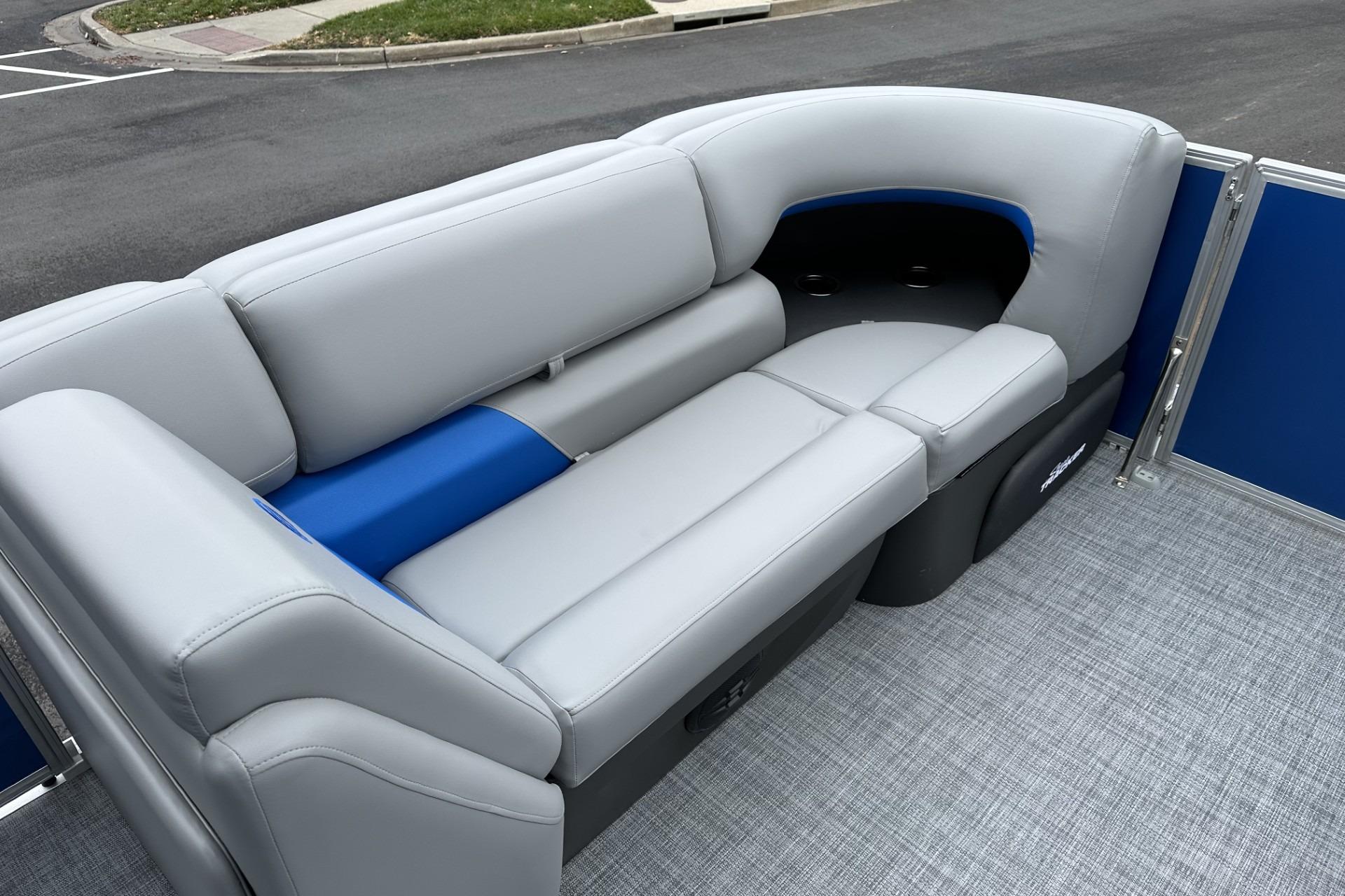 2026 Sun Tracker Party Barge 20 DLX interior seating with gray and blue upholstery.