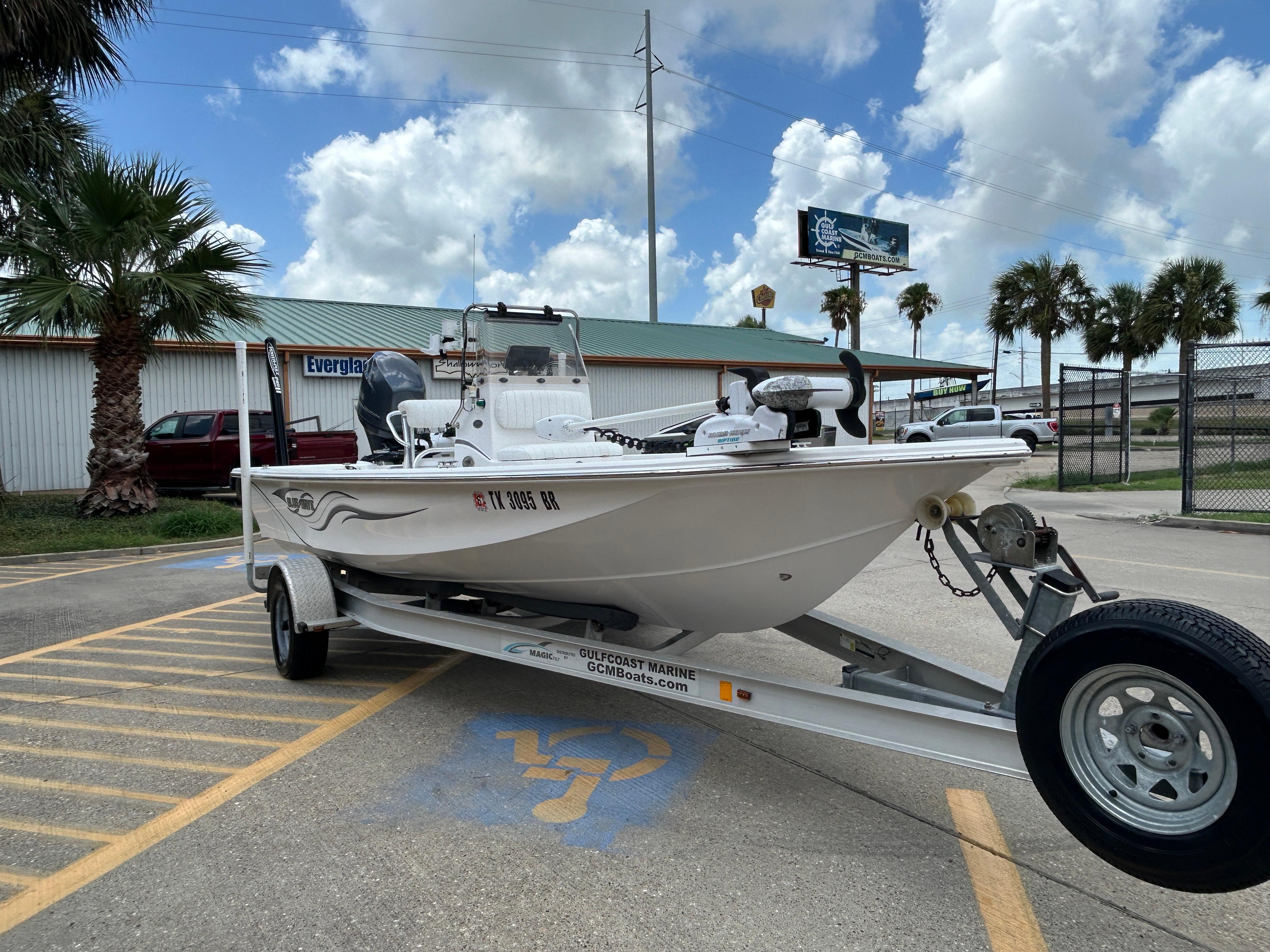 2012 Blue Wave 1900 STL boat on trailer in parking lot, palm trees in background.