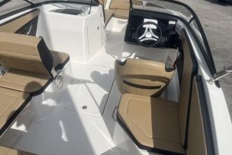 2017 Sea Ray SPX 210 Outboard interior with beige seating and steering console.