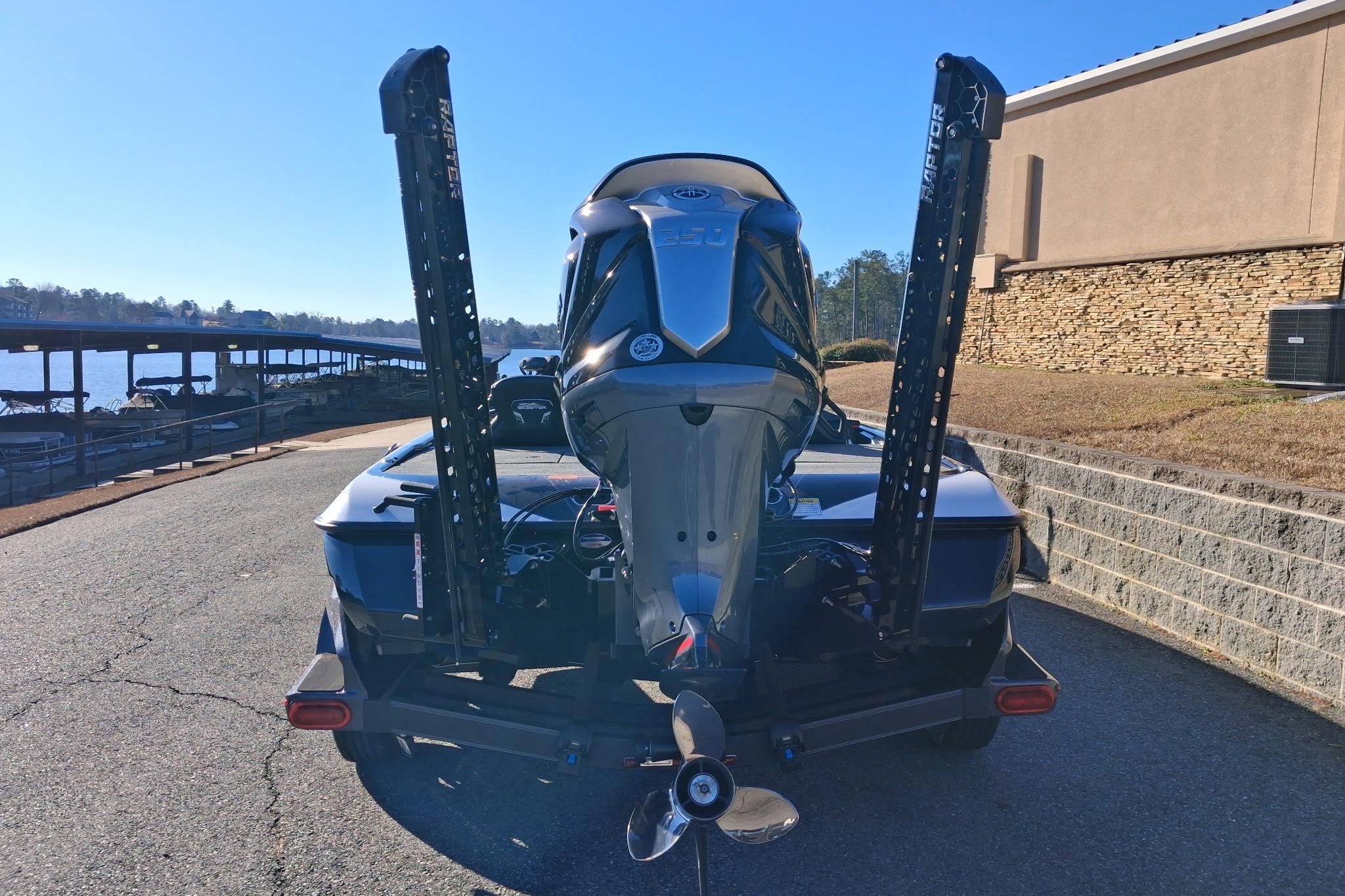 2026 Skeeter FXR21 FLEX boat with powerful outboard motor, parked near a lakeside dock.