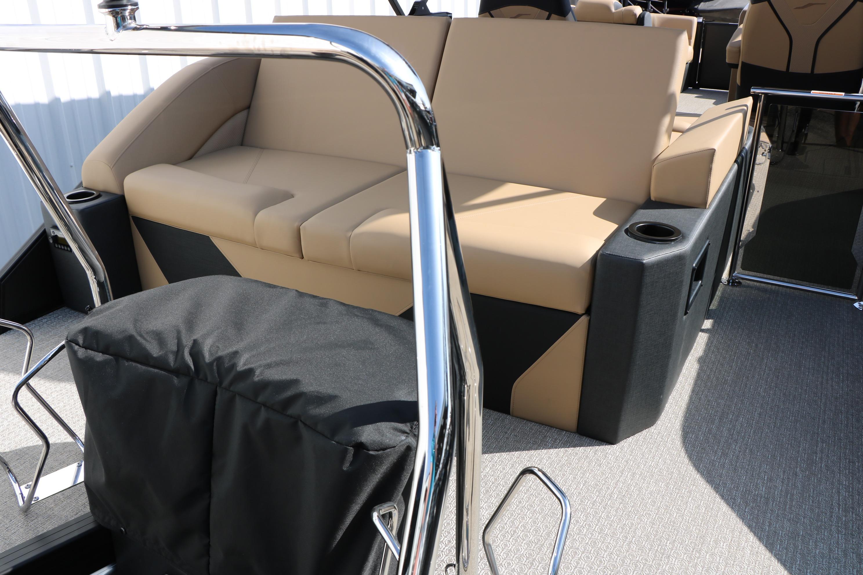 Luxurious seating on 2026 Evotti 723CS boat with beige upholstery and cup holders.
