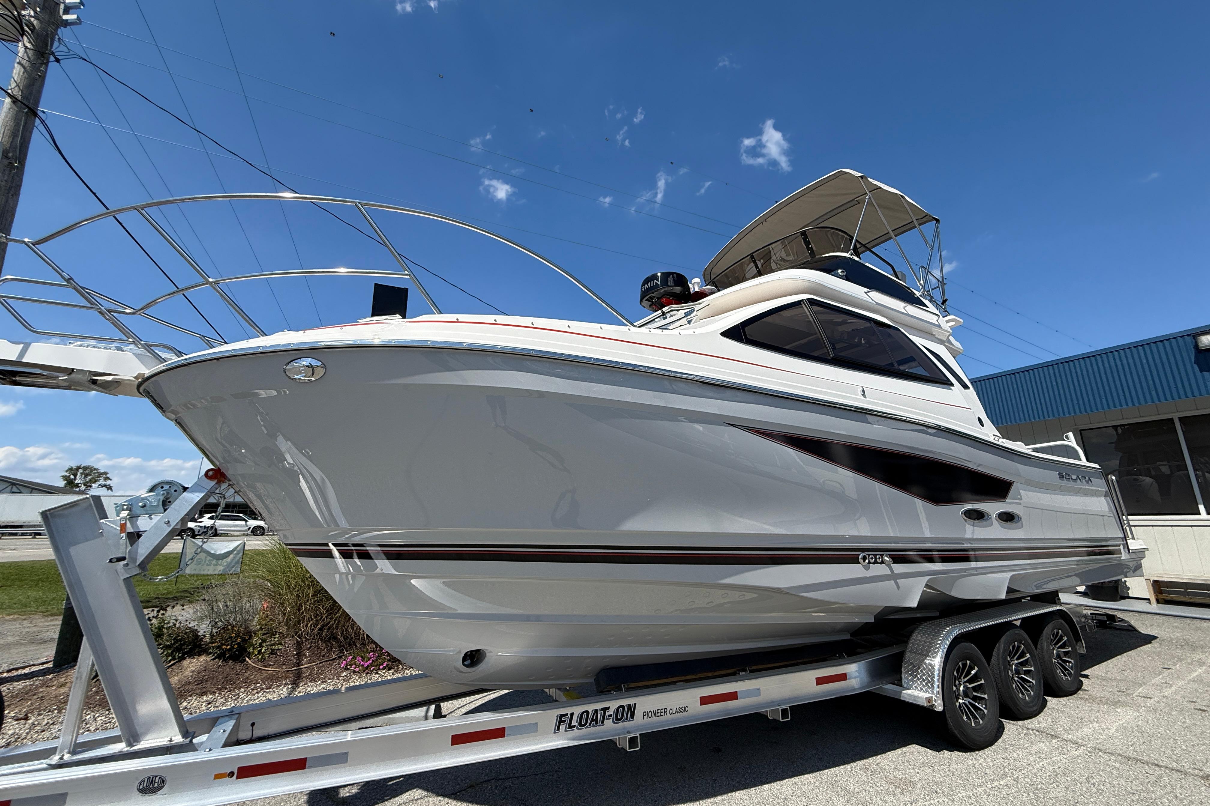 2026 Solara S-310 SB boat on trailer under clear blue sky.
