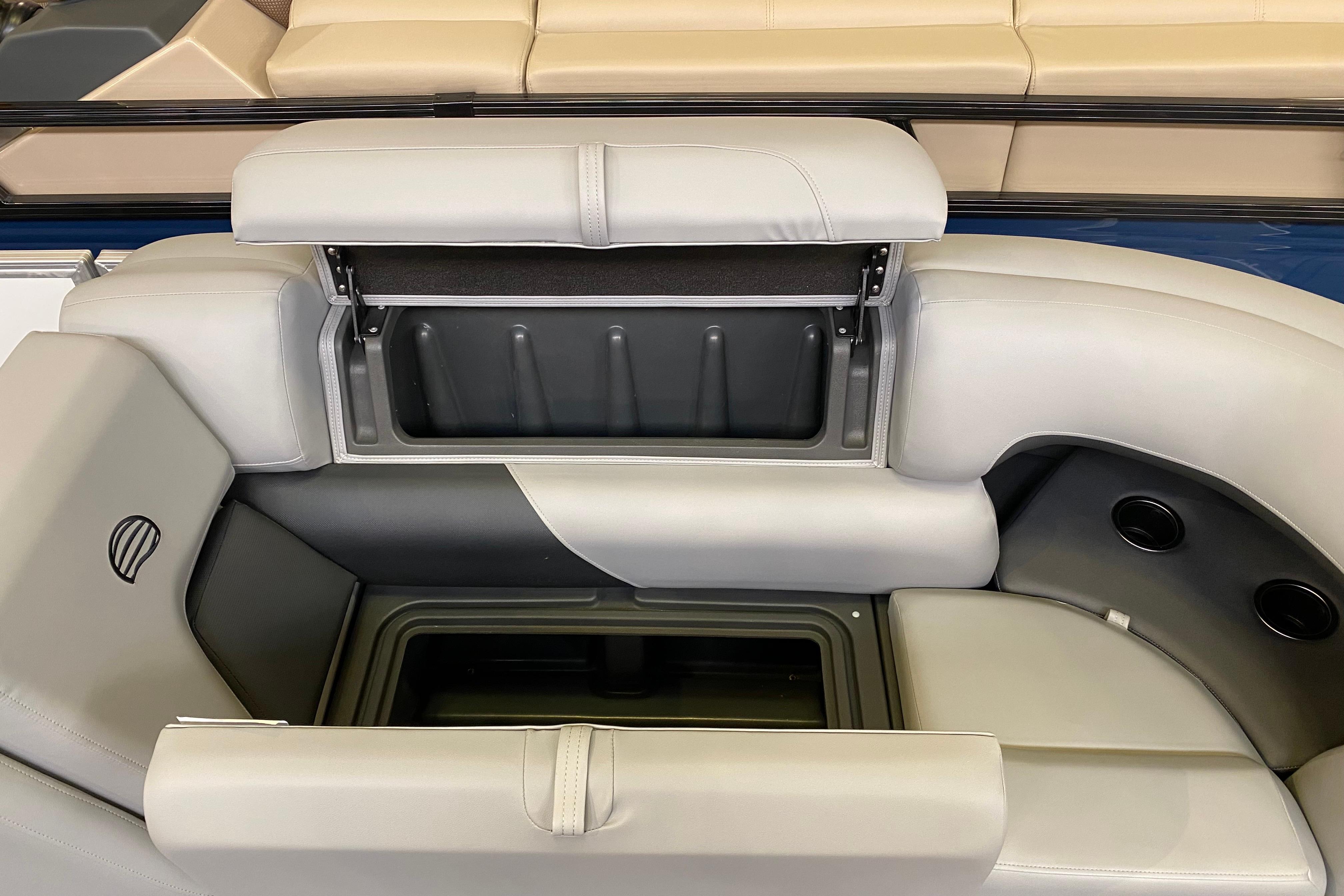 2026 Sun Tracker Party Barge 22 DLX seating with storage compartment open.