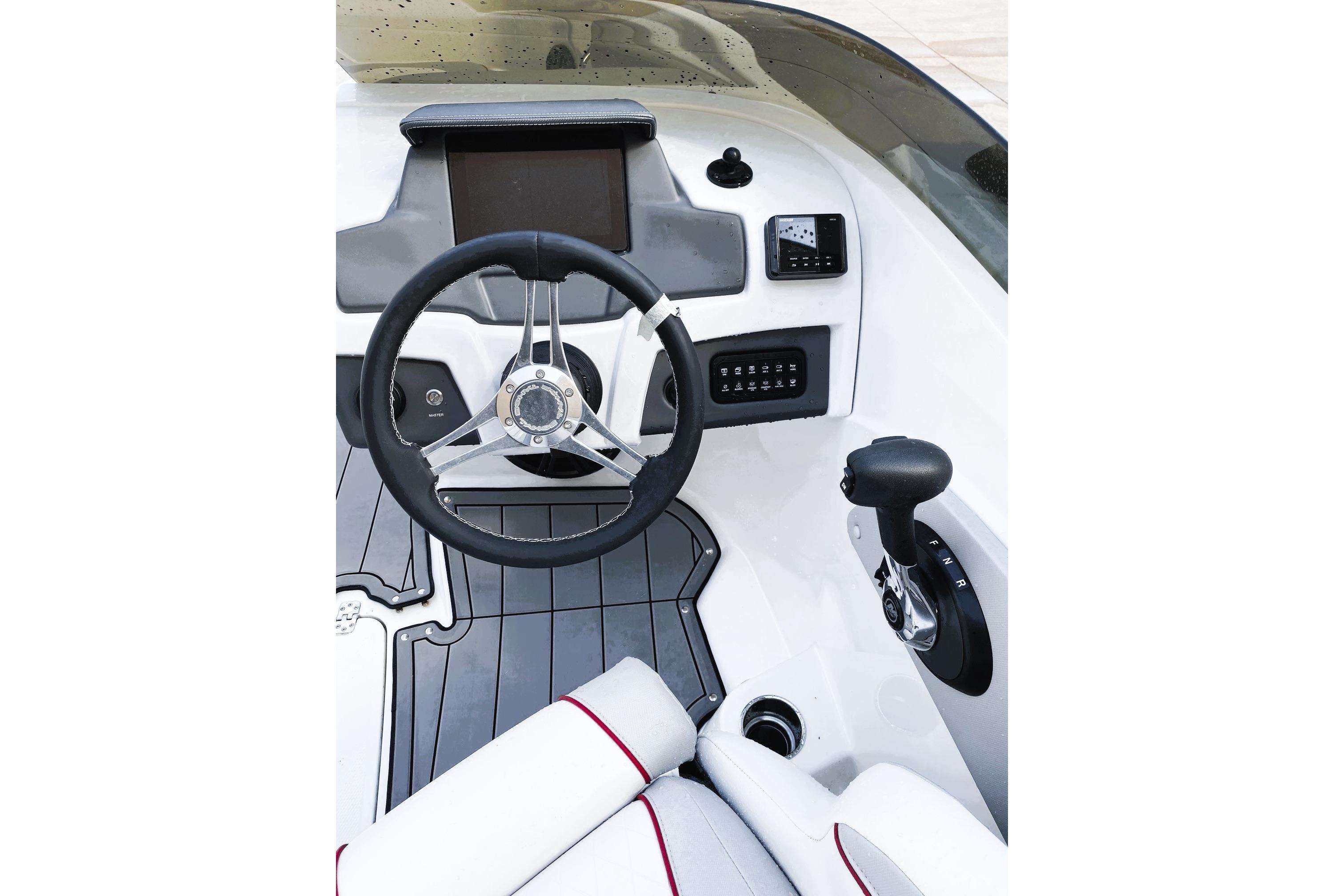 2023 Tahoe 210 Si Limited boat dashboard with steering wheel and controls.