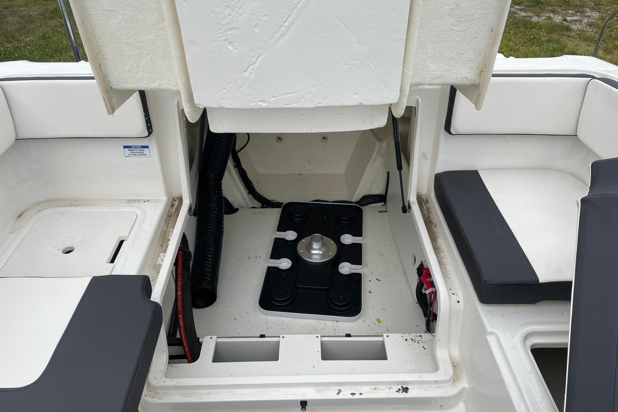2023 Bayliner VR4 Bowrider OB interior storage compartment with seating and mechanical access.