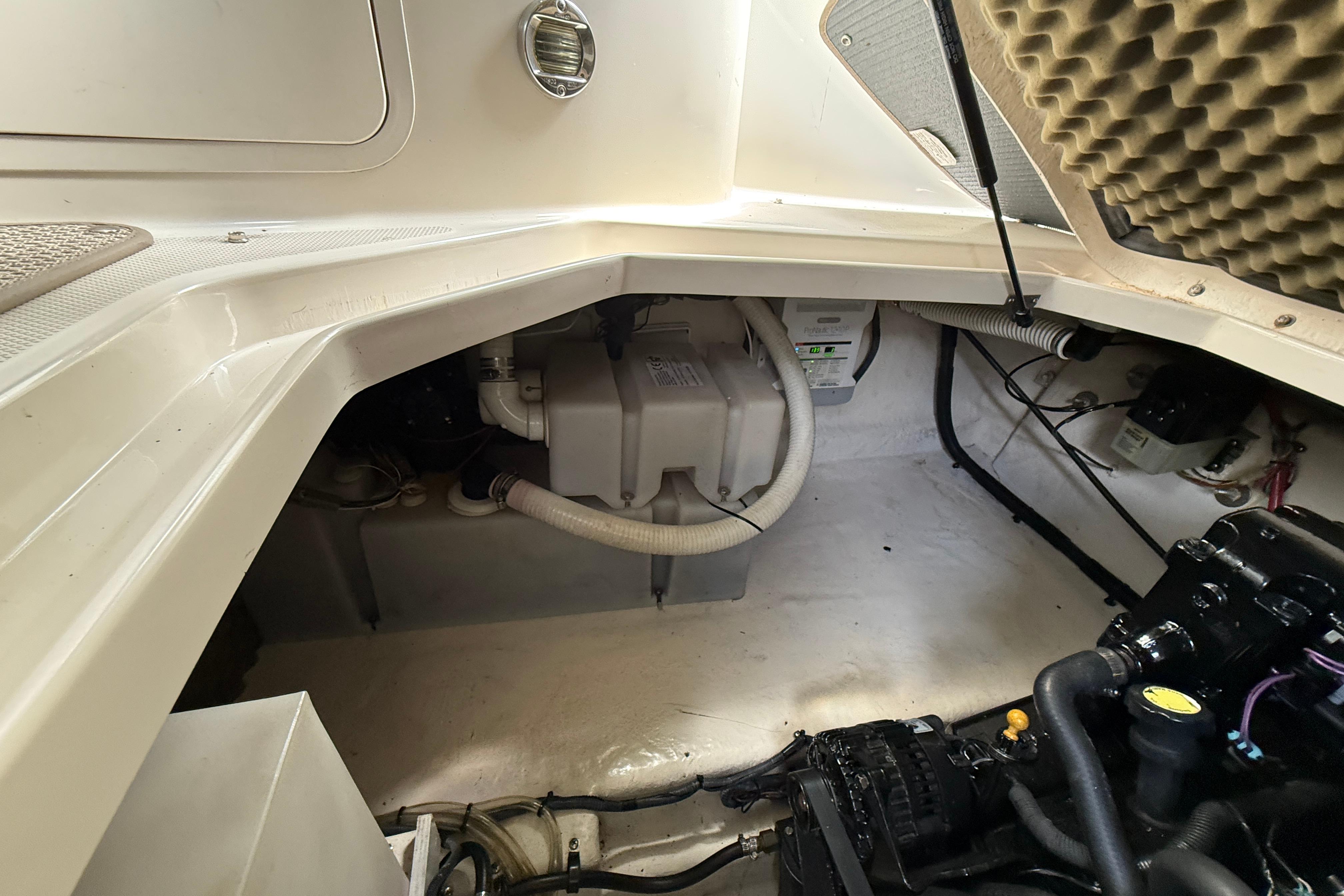 Engine compartment of a 2004 Sea Ray 240 Sundancer boat, showcasing mechanical components.