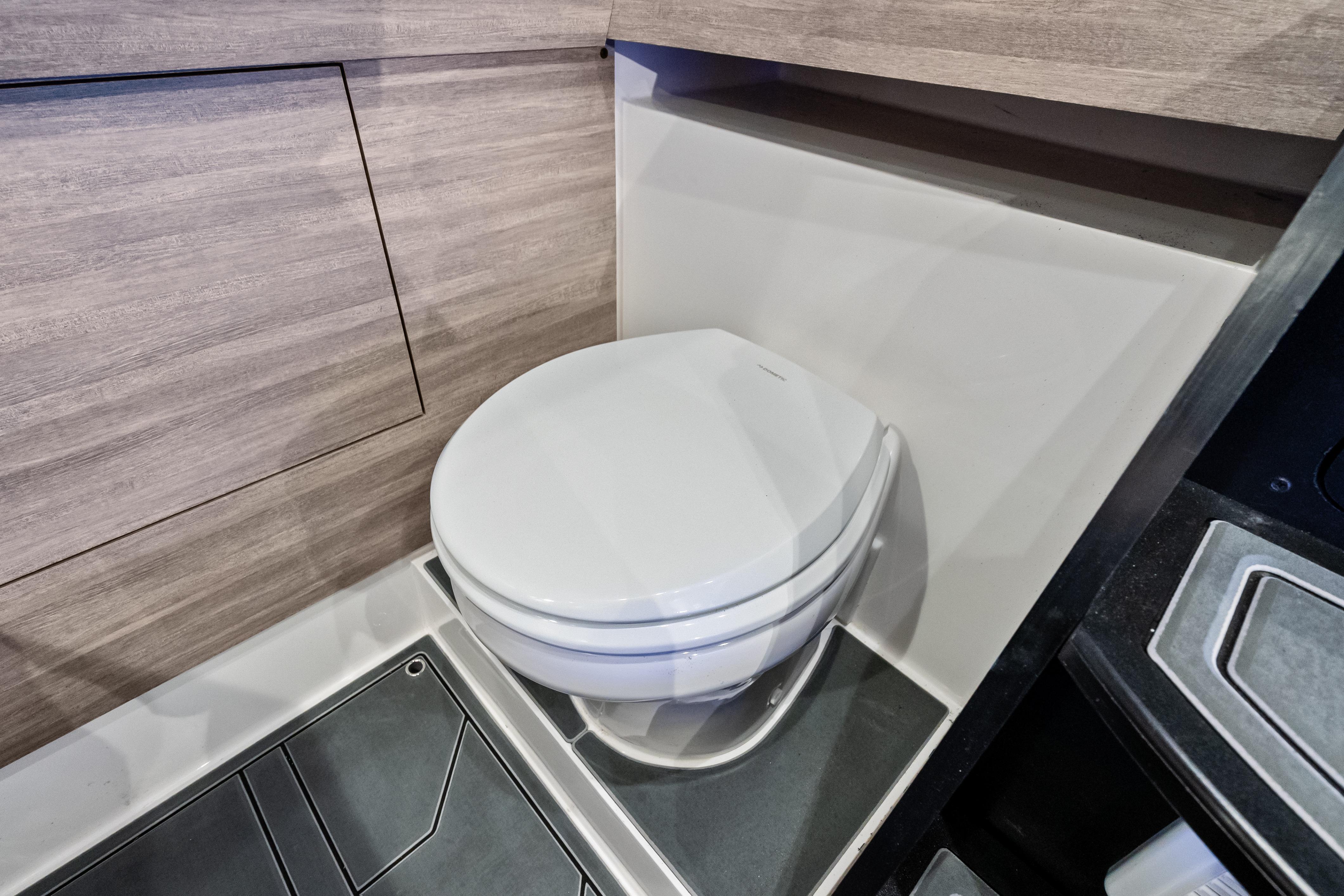 2027 Mystic Powerboats M4200 interior bathroom with modern toilet design.