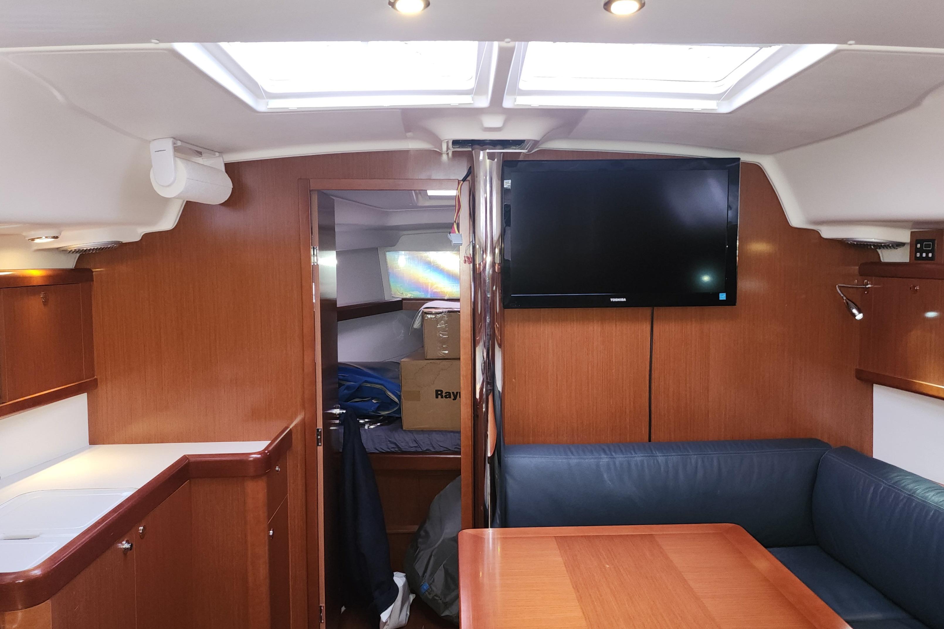 Interior of 2012 Beneteau Oceanis 40 yacht with wood finish and seating area.