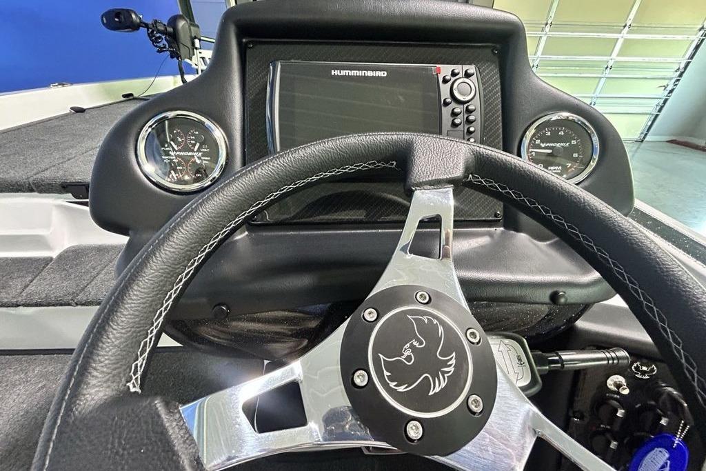 Steering wheel and dashboard of 2026 Phoenix 818 Pro boat with gauges and electronics.