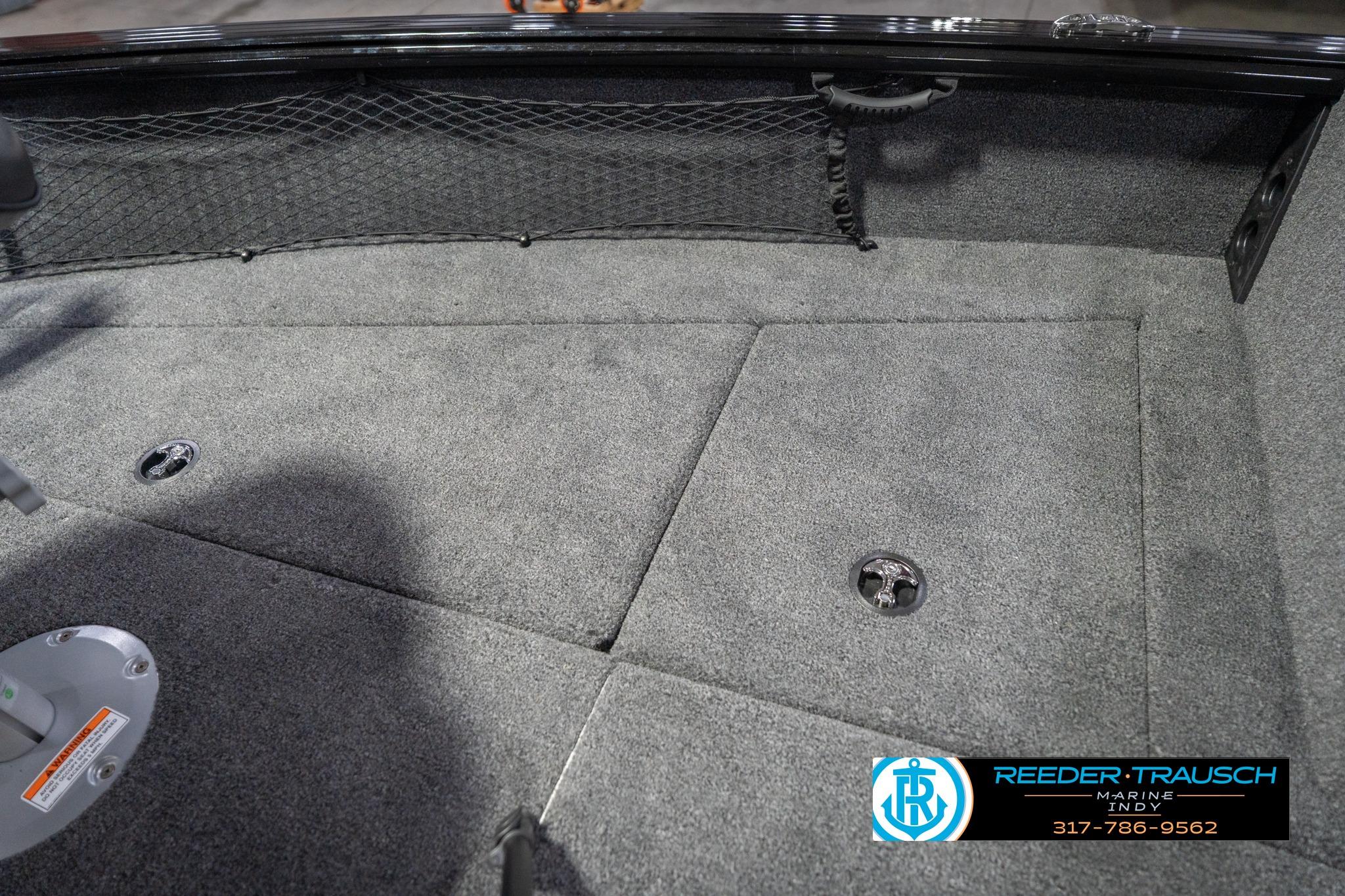 2026 Lund 2075 Impact XS boat interior with carpeted flooring and storage compartments.