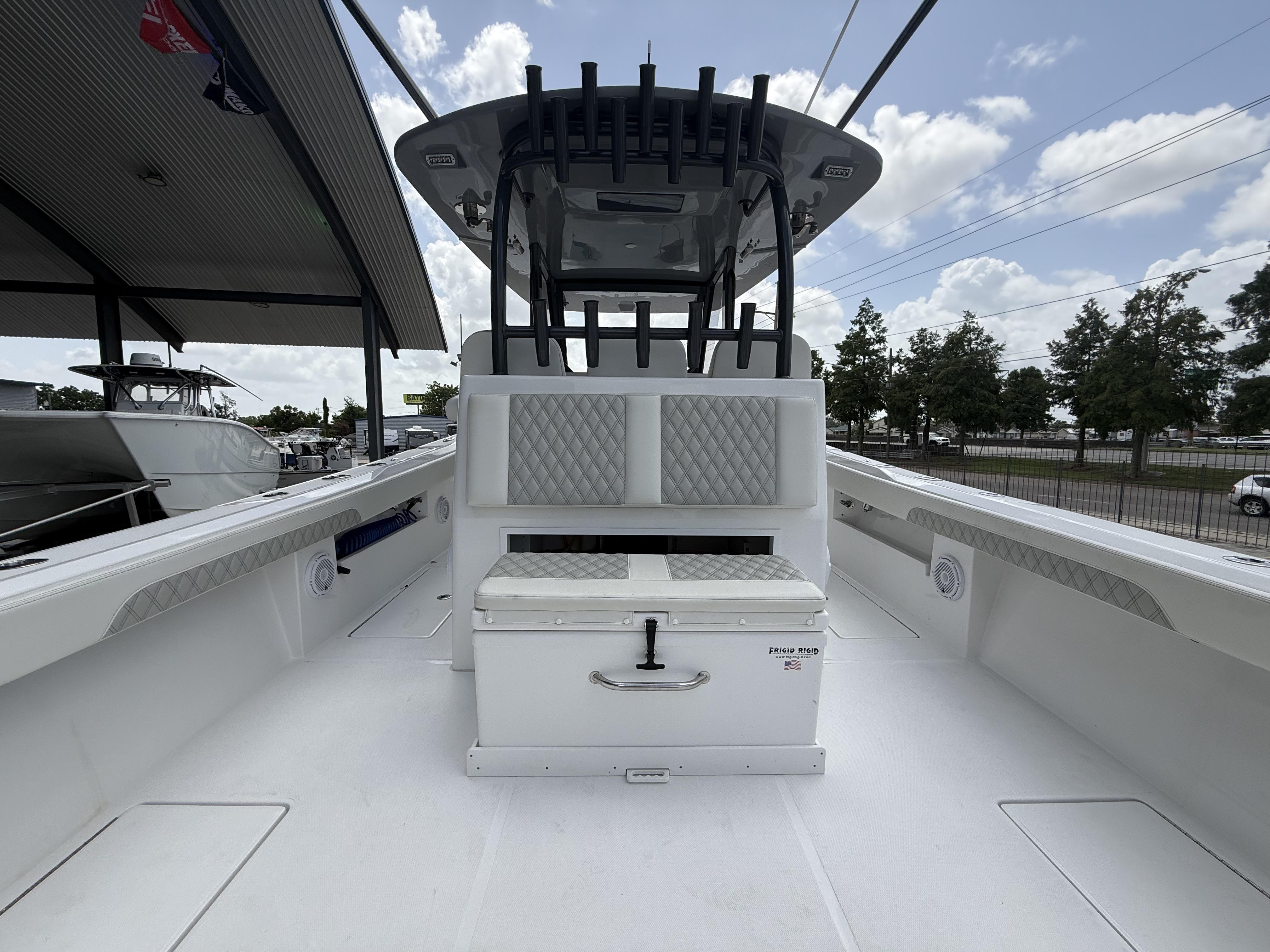 2024 Front Runner 39 CC boat interior with seating and storage under a cloudy sky.