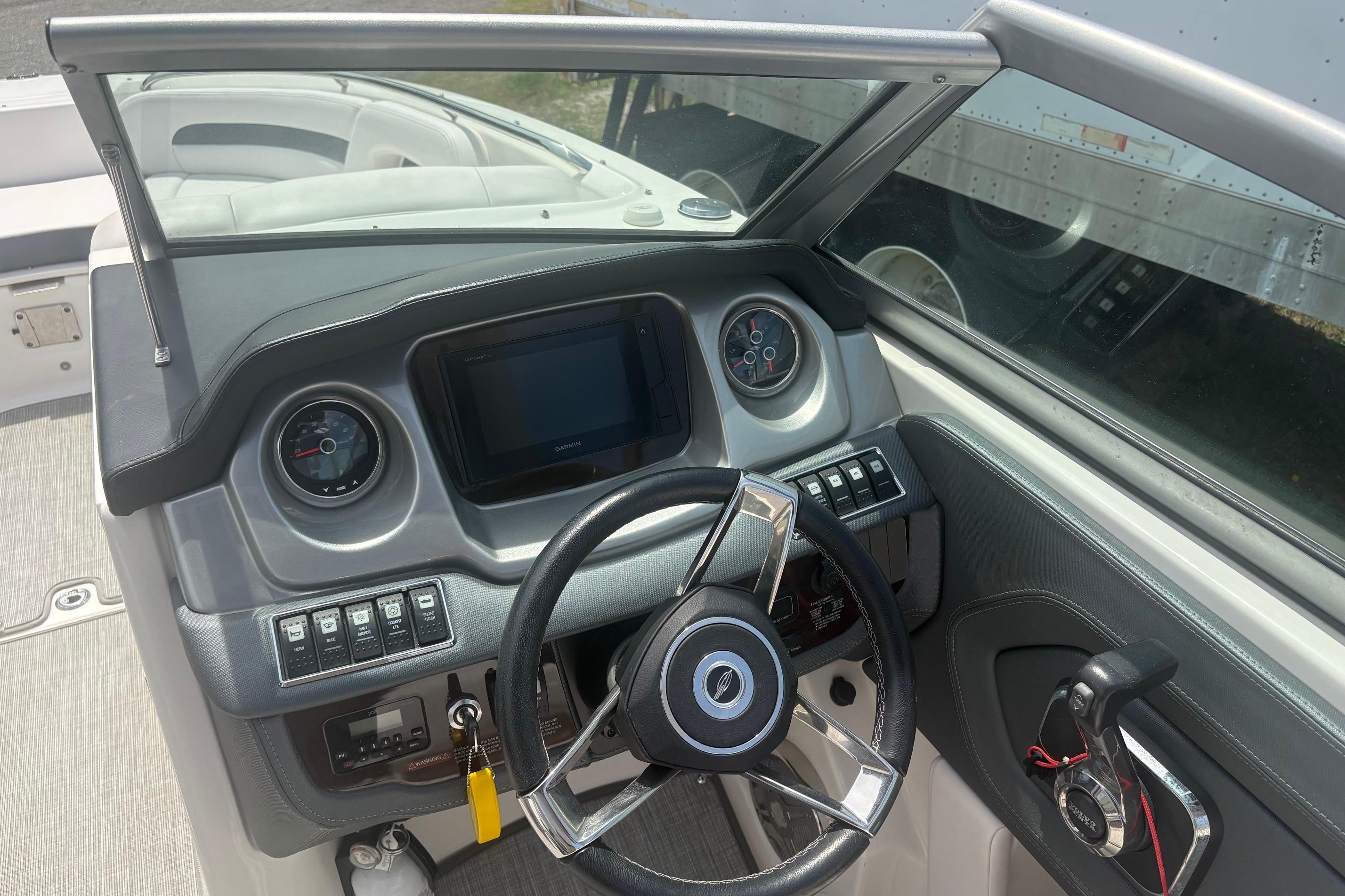 2019 Chaparral 264 Sunesta boat dashboard with steering wheel and control panel.