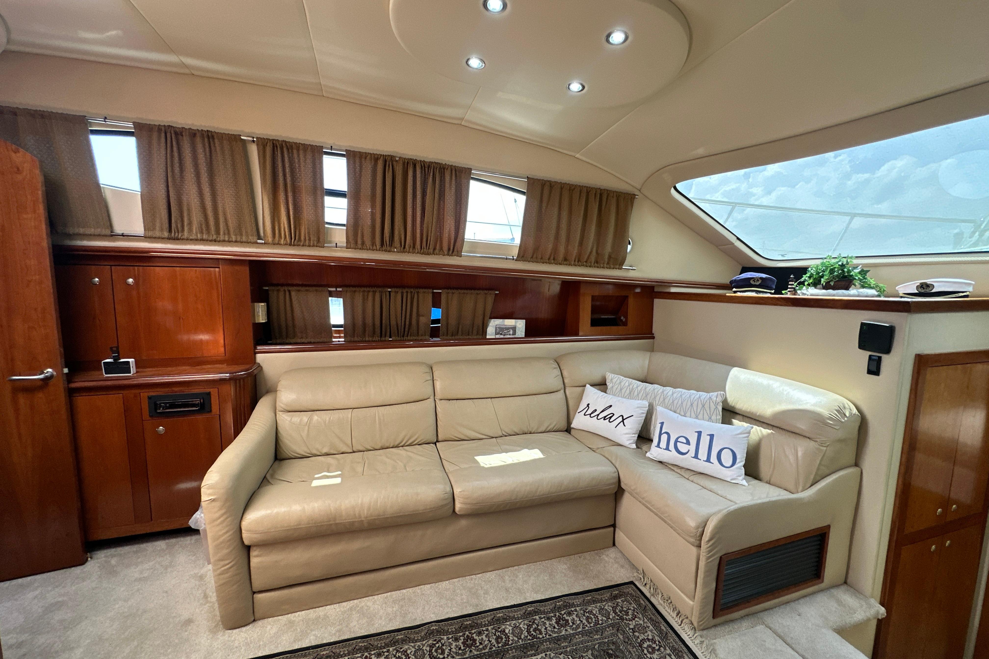 Luxurious 2004 Cruisers Yachts 405 Express Motoryacht interior with beige leather seating.