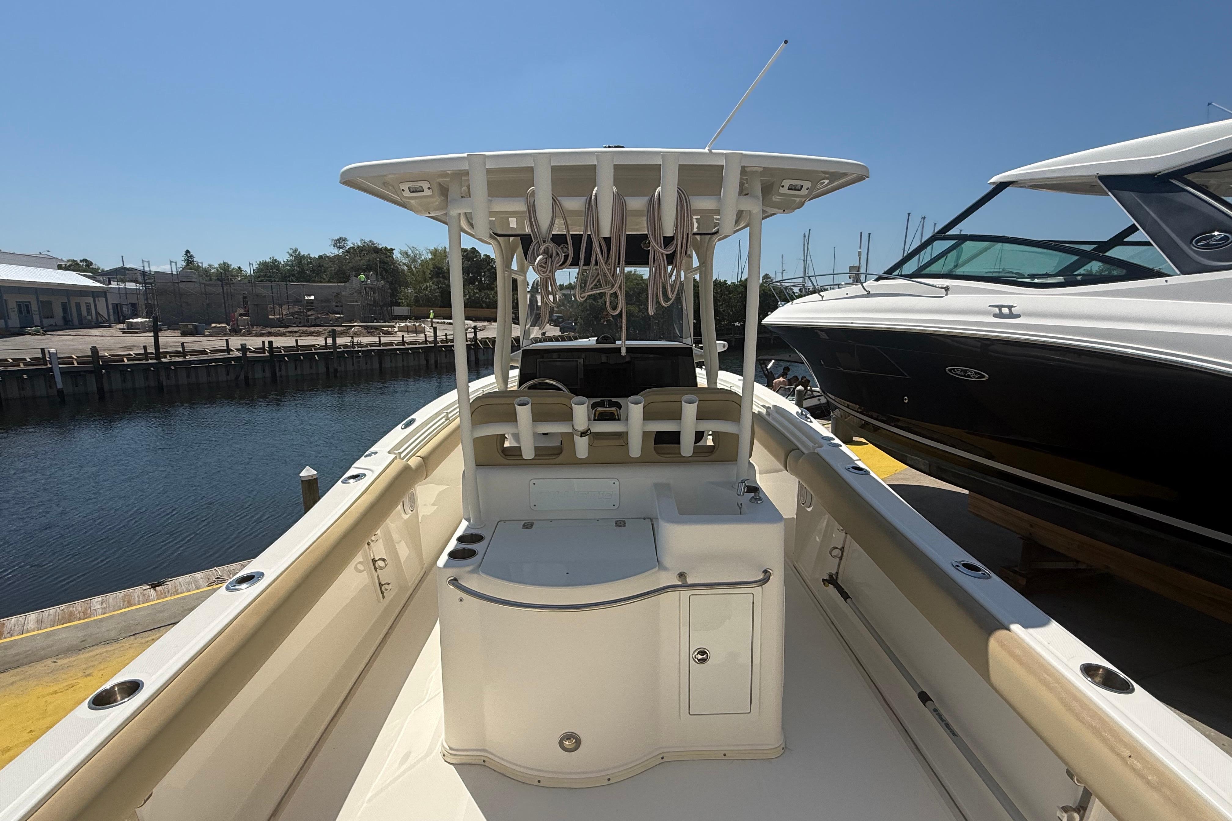 2019 Key West Billistic 281 Center Console boat docked near water.