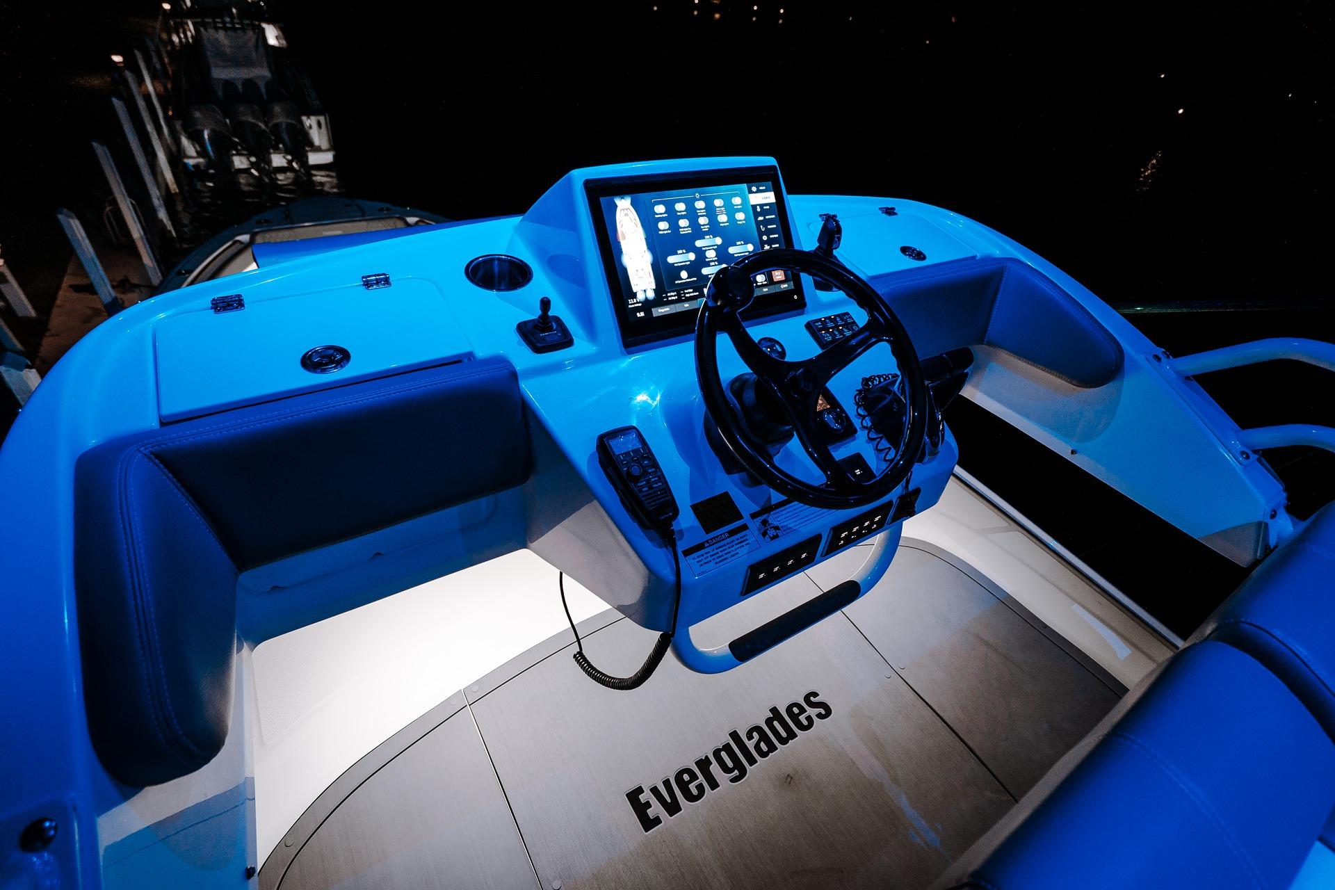 2026 Everglades 455 Center Console boat cockpit with illuminated controls and steering wheel.