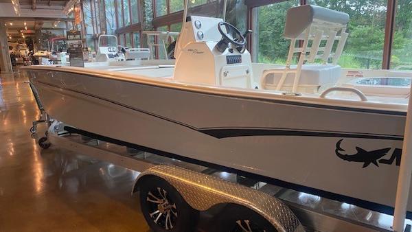 2023 Mako Pro Skiff 19 CC boat on display in a showroom.