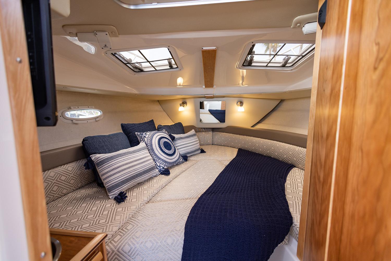 Manufacturer Provided Image: 2023 Cutwater C-248 Coupe interior cabin with cozy bedding and nautical decor.