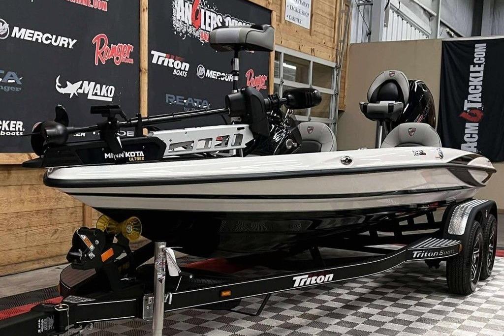 2026 Triton 18 TrX boat on display, featuring Minn Kota Ultrex trolling motor.