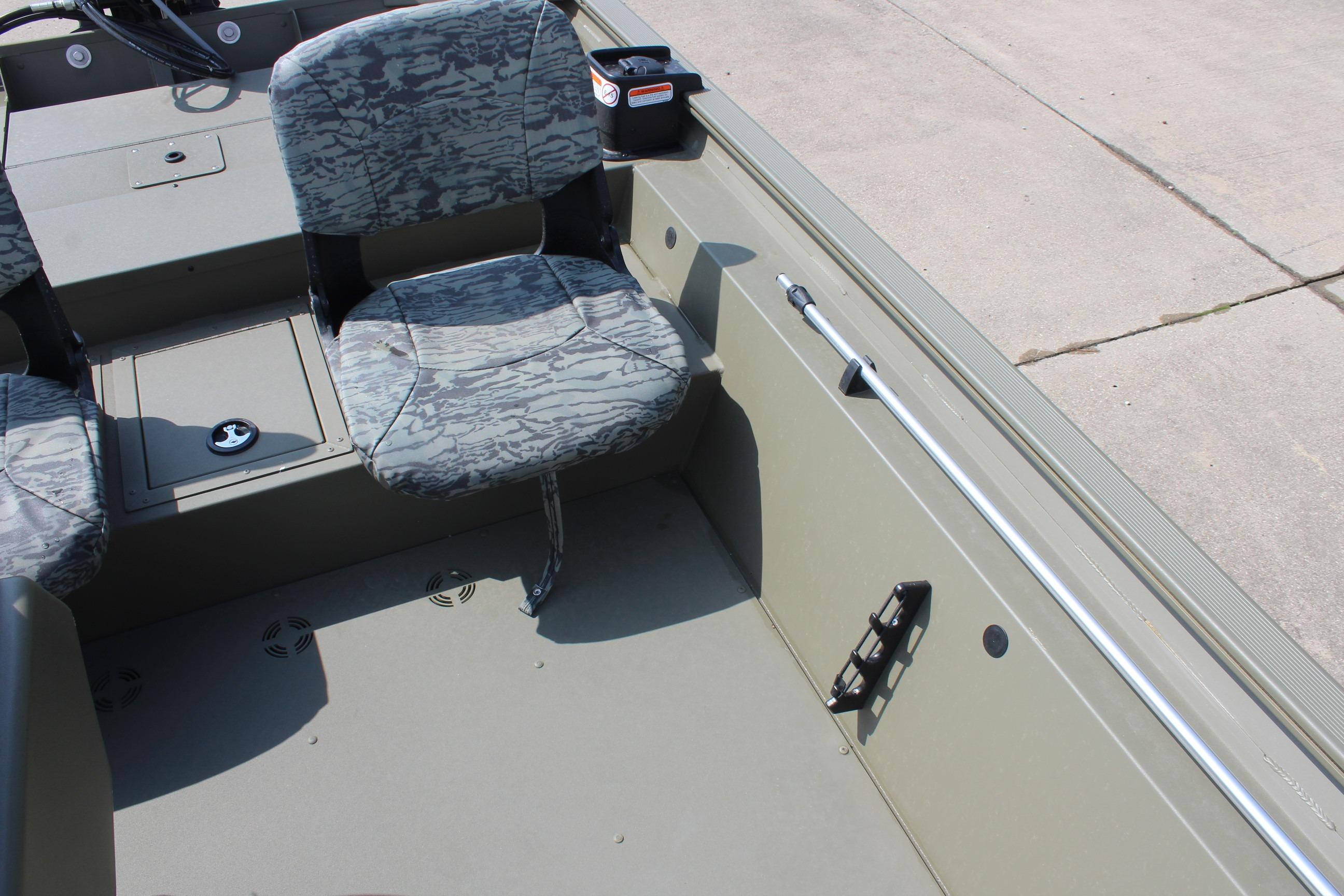 2026 Tracker Grizzly 1754 SC boat interior with camo seats and rod holder.