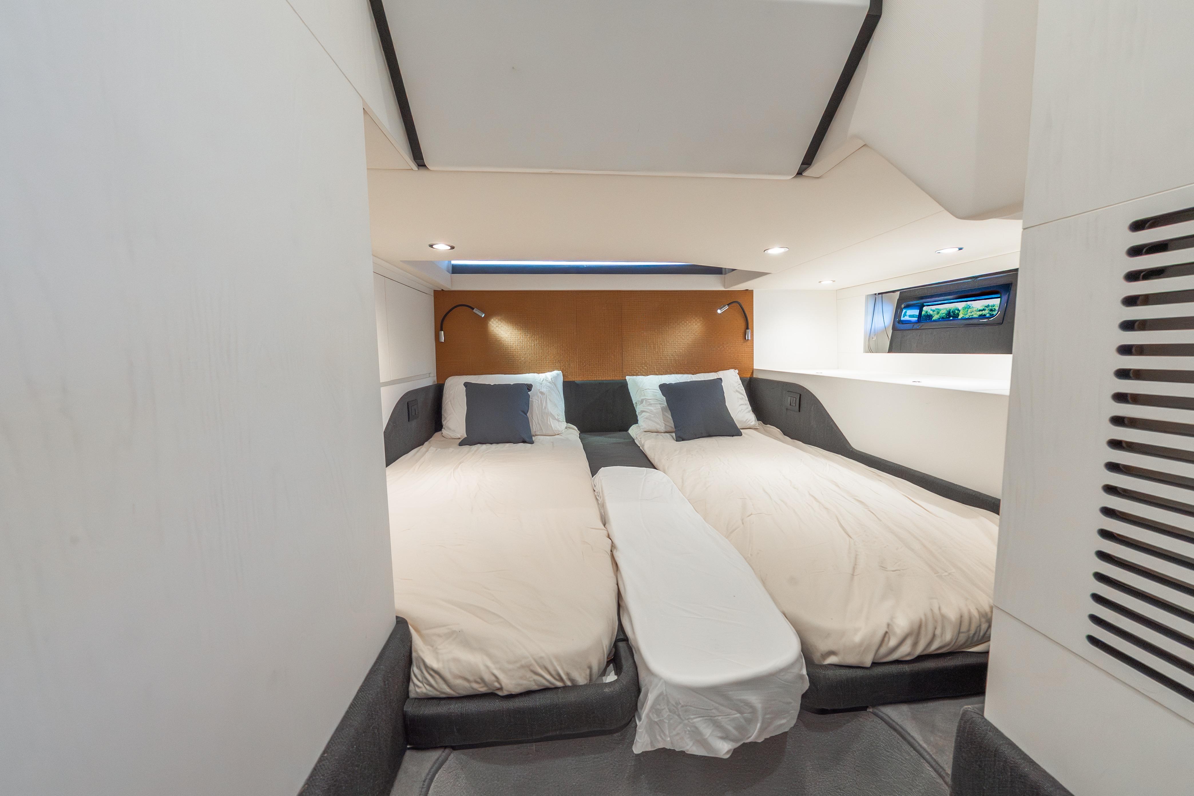 Luxurious cabin interior of 2023 Azimut Verve 47 yacht with twin beds and modern design.