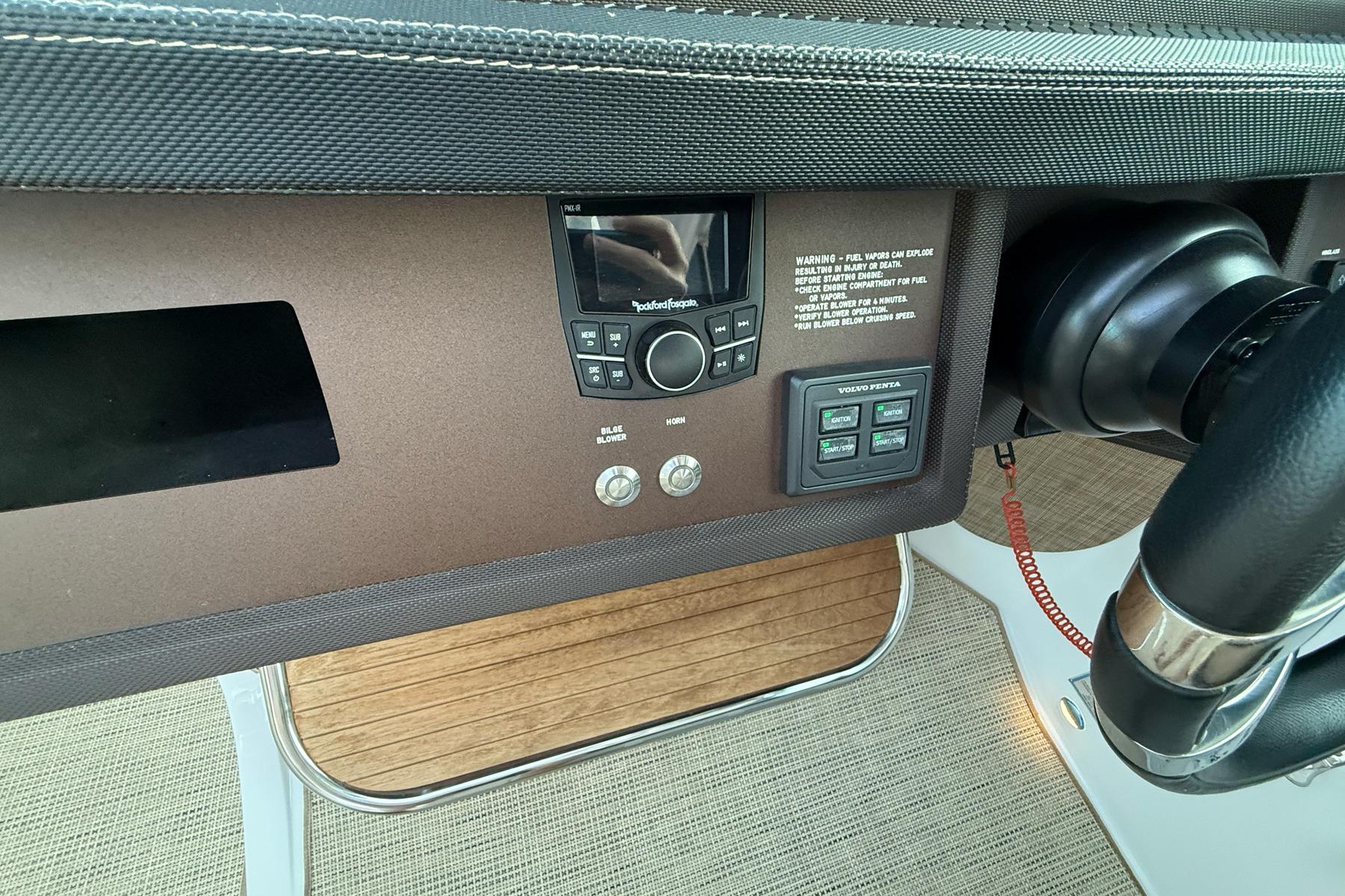 Control panel of a 2017 Cobalt A40 Coupe boat with steering wheel and electronic controls.