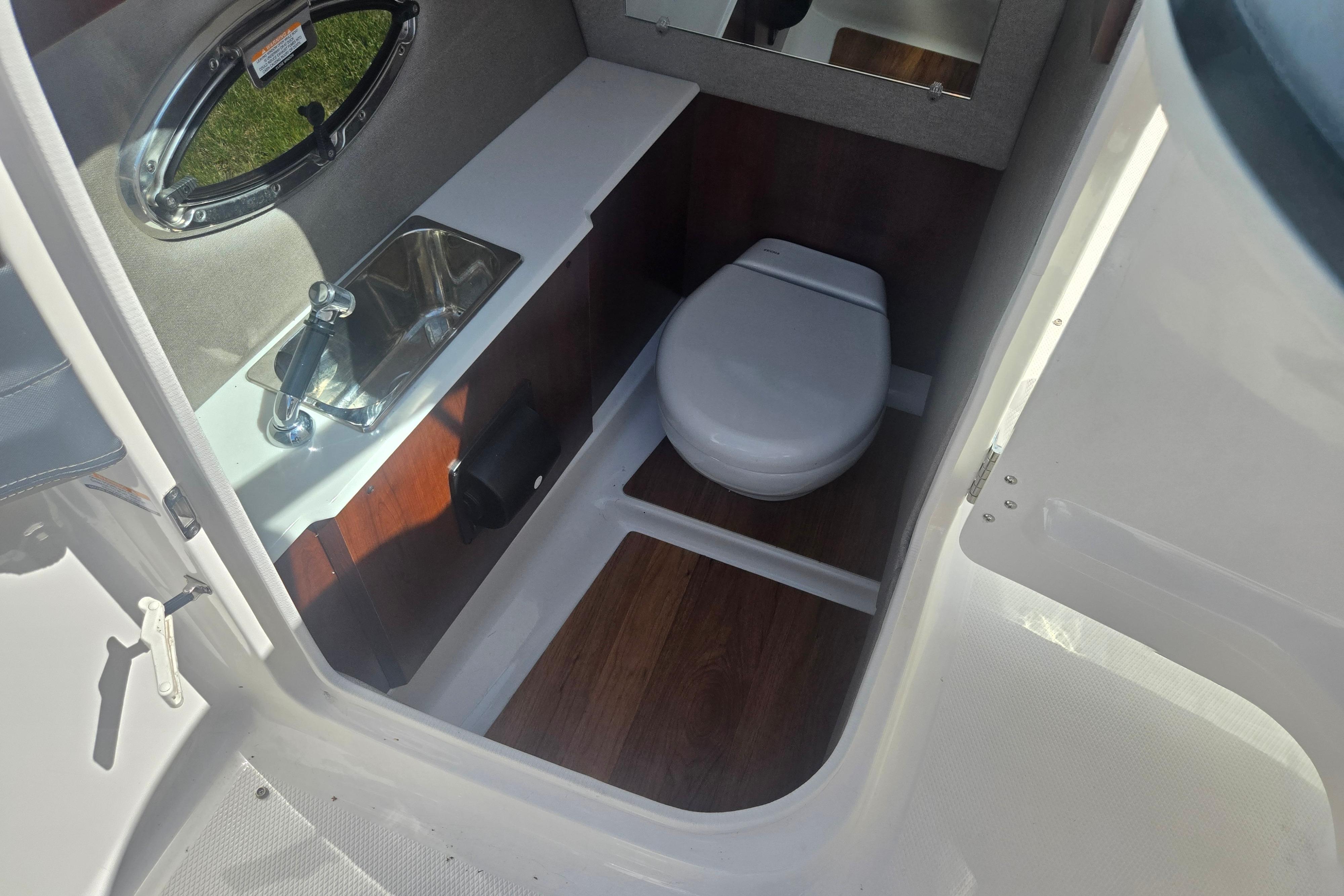 2018 Chaparral 267 SSX boat interior with sink and toilet.
