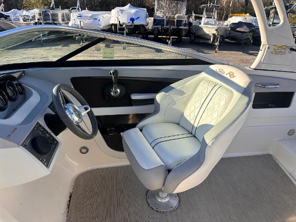 2016 Sea Ray 240 Sundeck interior with steering wheel and captain's chair.