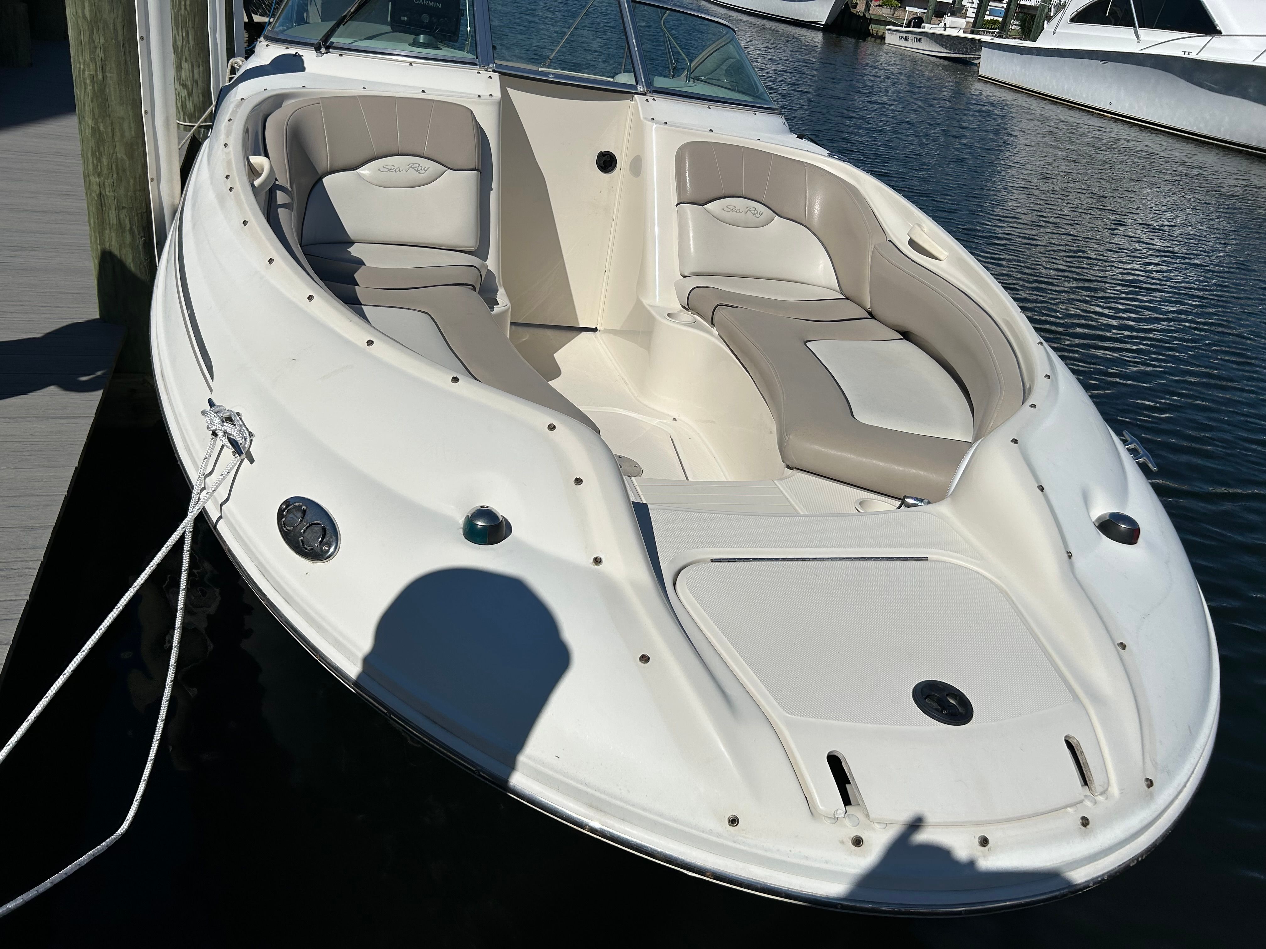 2003 Sea Ray 240 Sundeck boat docked at marina.