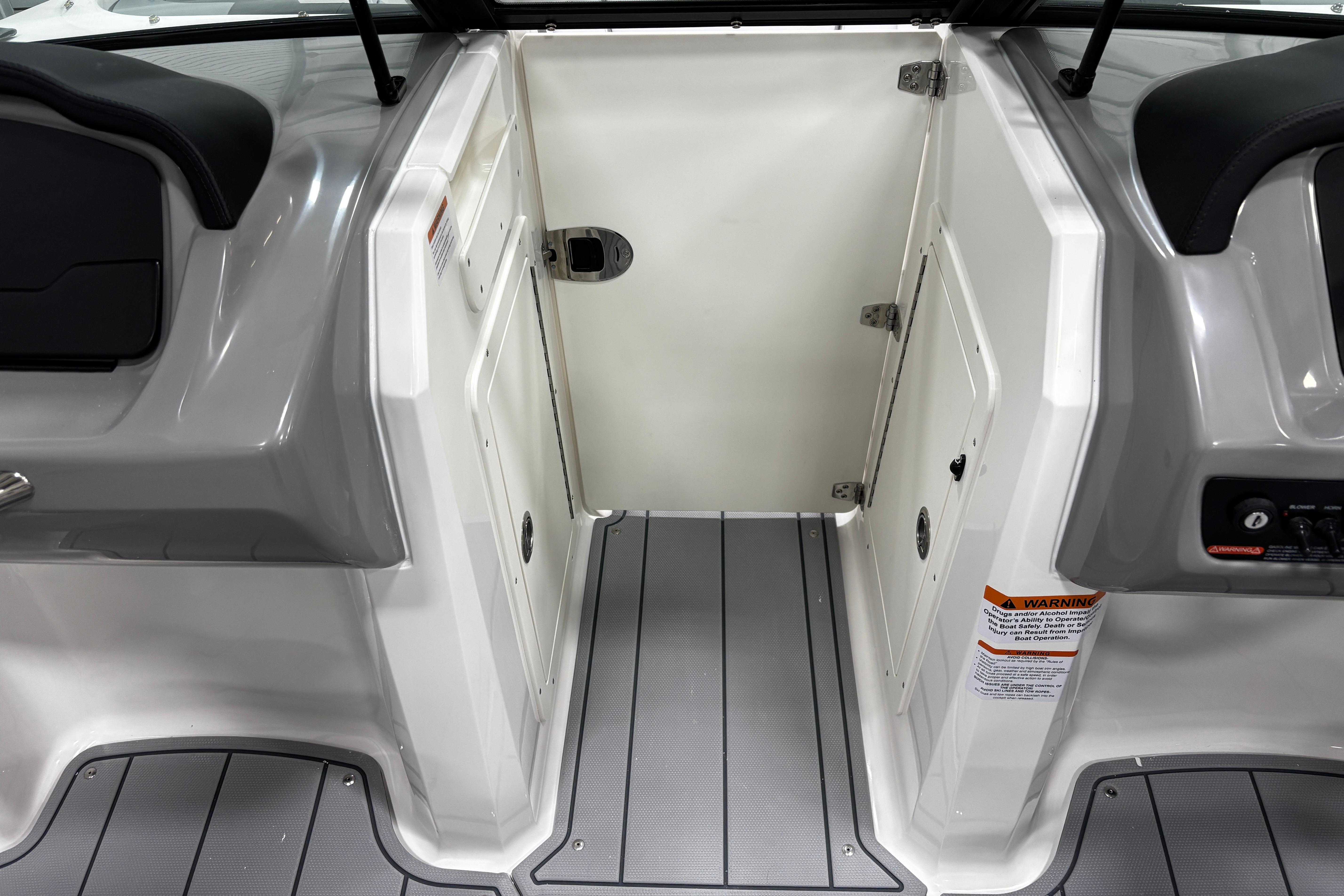2026 Chaparral 21 SSi boat interior with gray flooring and storage compartments.