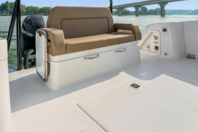 2026 Cruisers Yachts 38 VTR interior with tan seating, overlooking a scenic waterway.