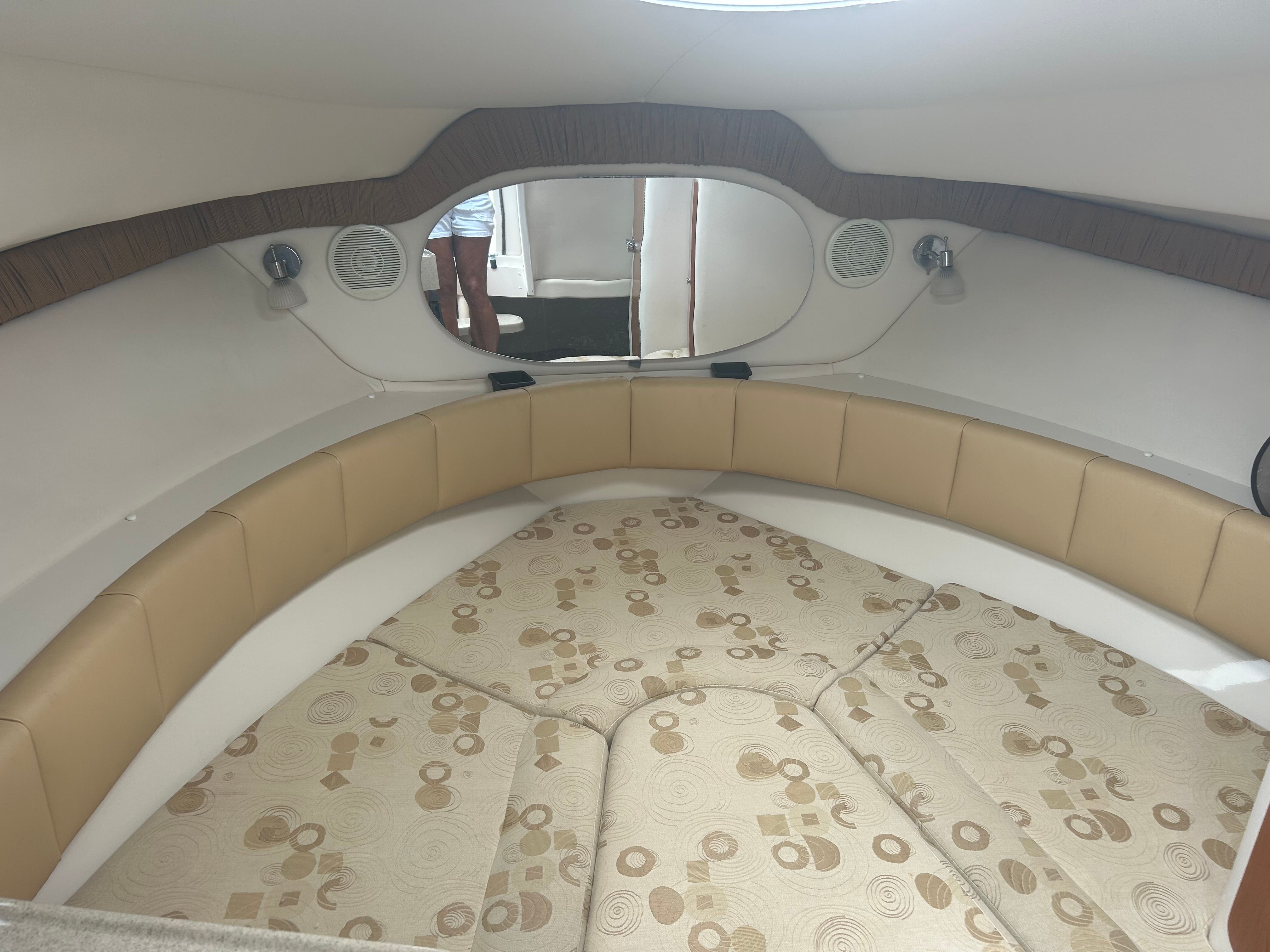 Interior of a 2007 Wellcraft 27' Coastal with cushioned seating and round windows.