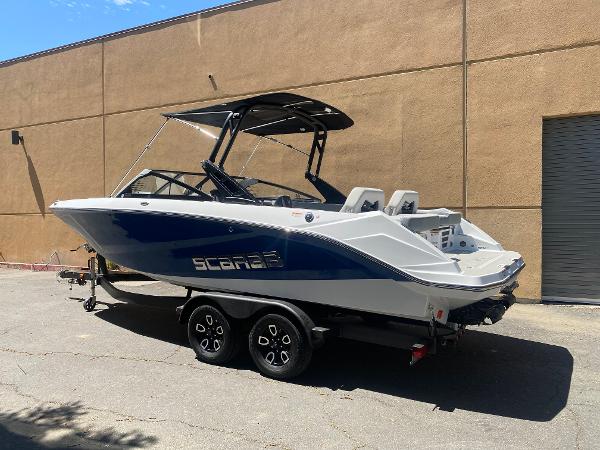 2025 Scarab 235 SE boat on trailer, parked outdoors, side view.