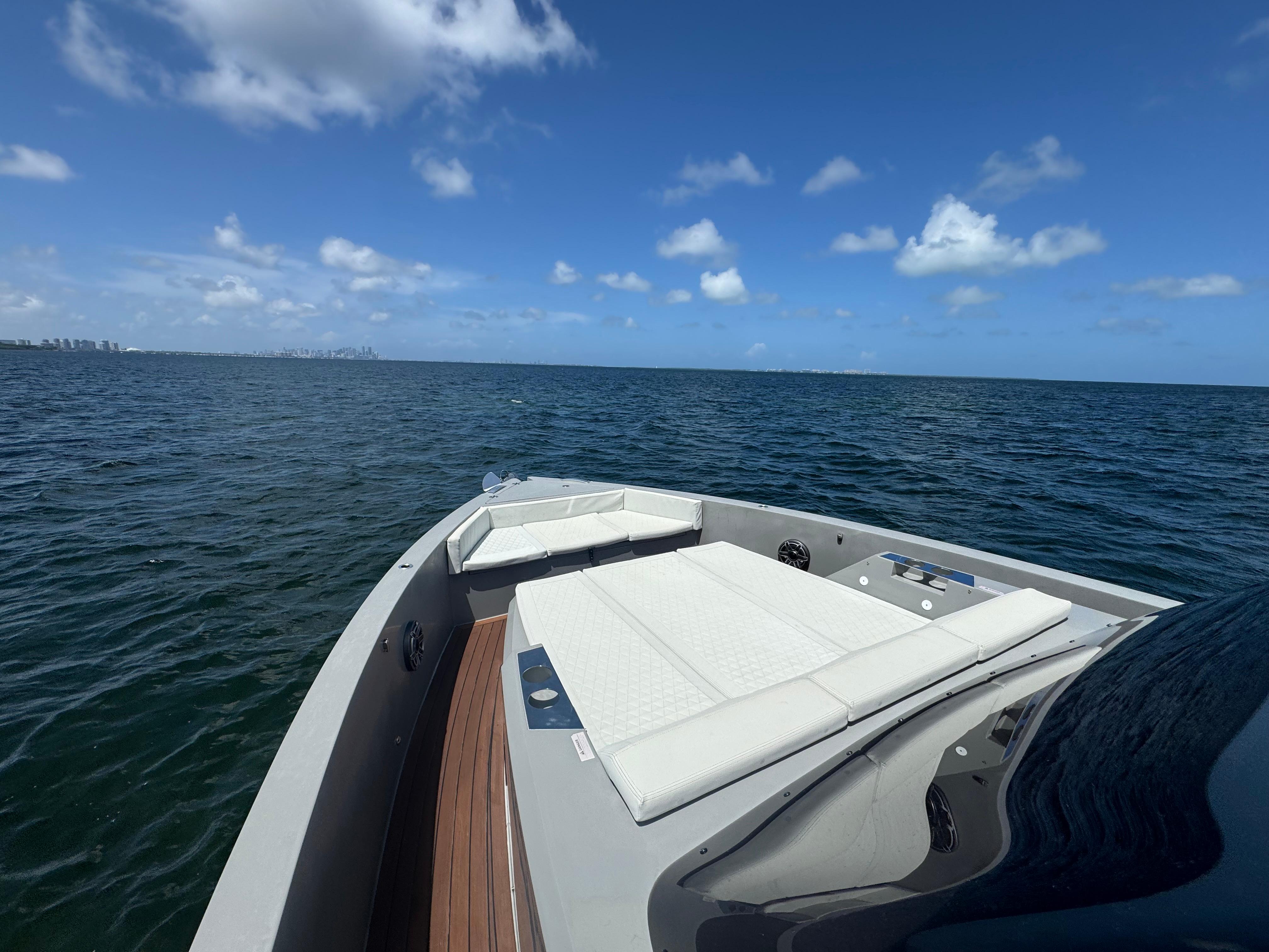 Luxury De Antonio Yachts D42, 2021 model, cruising on open sea under clear blue sky.
