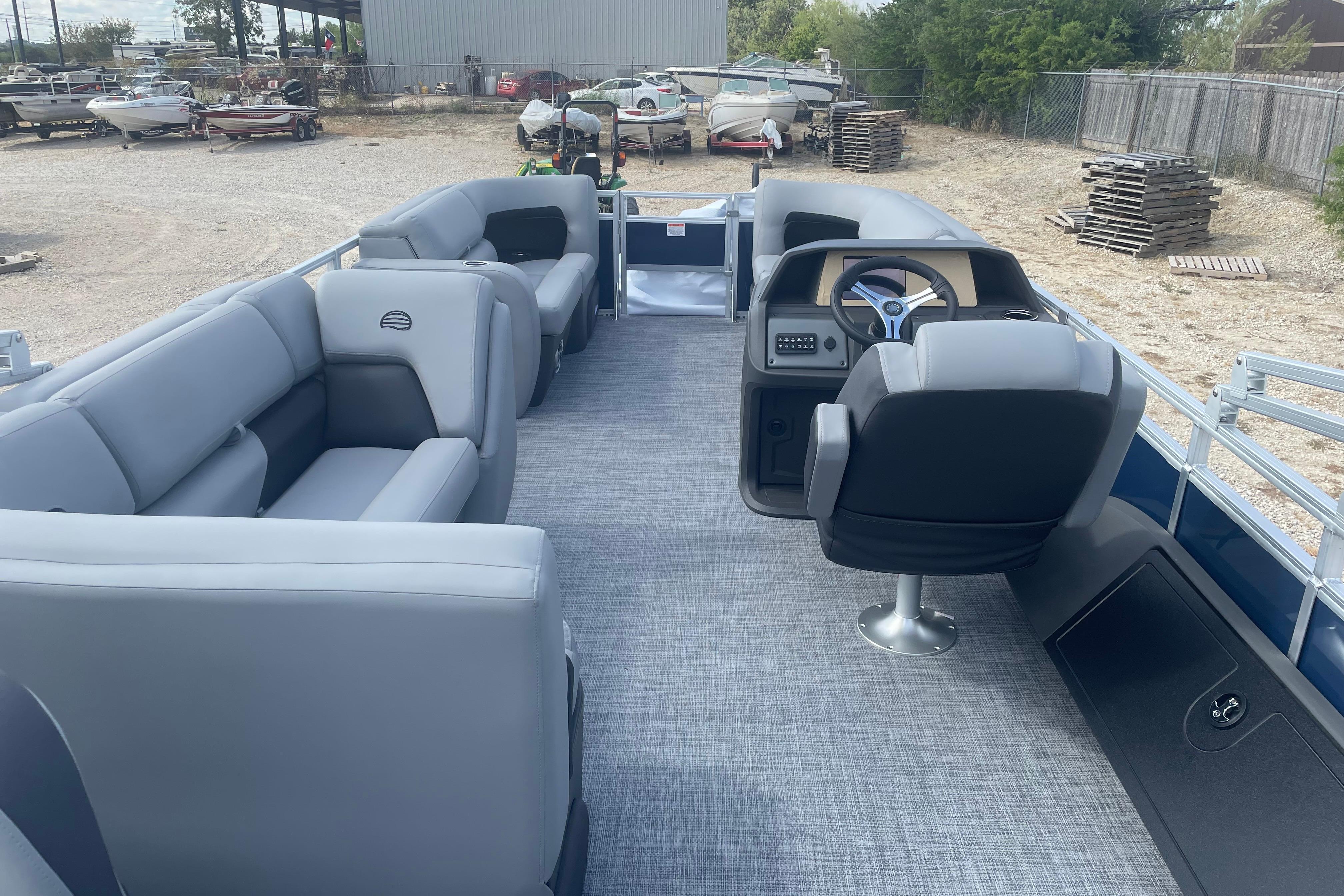 2026 Sun Tracker SportFish 22 DLX pontoon boat with spacious seating and modern helm.