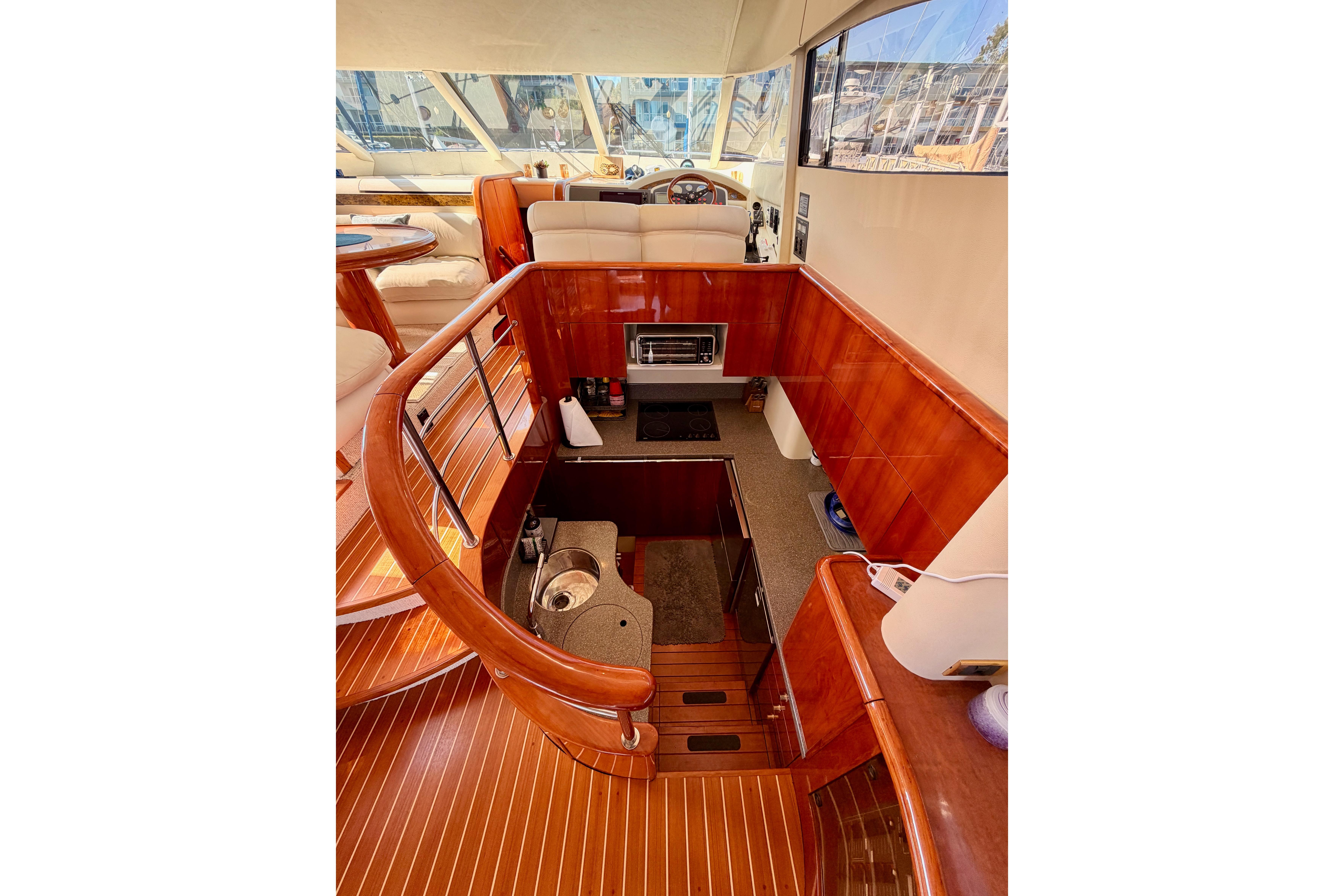 Luxurious interior of 2001 Fairline 55 yacht with elegant wood finishes and modern amenities.