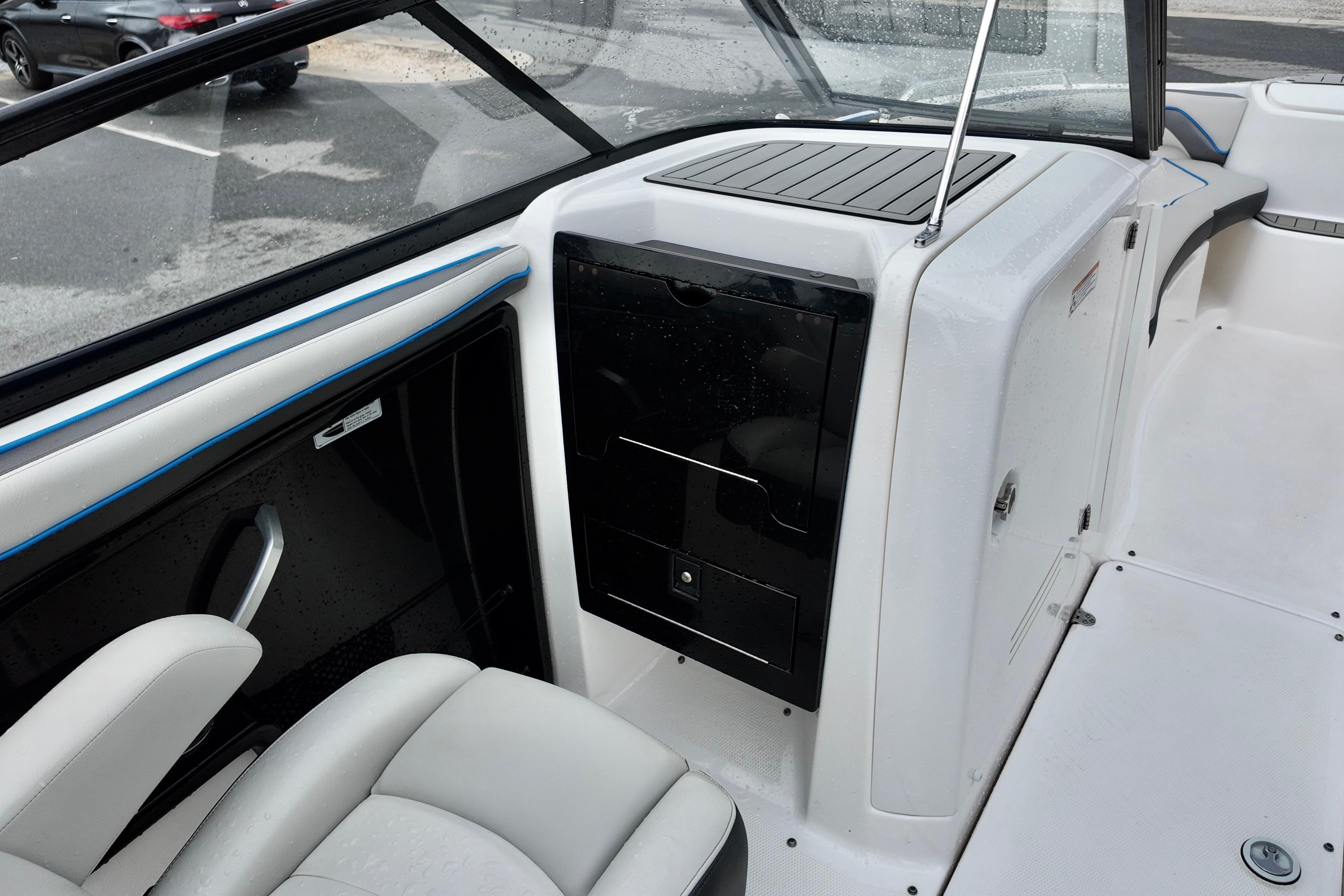 Interior view of 2020 Yamaha Boats AR240, featuring sleek seating and storage compartments.