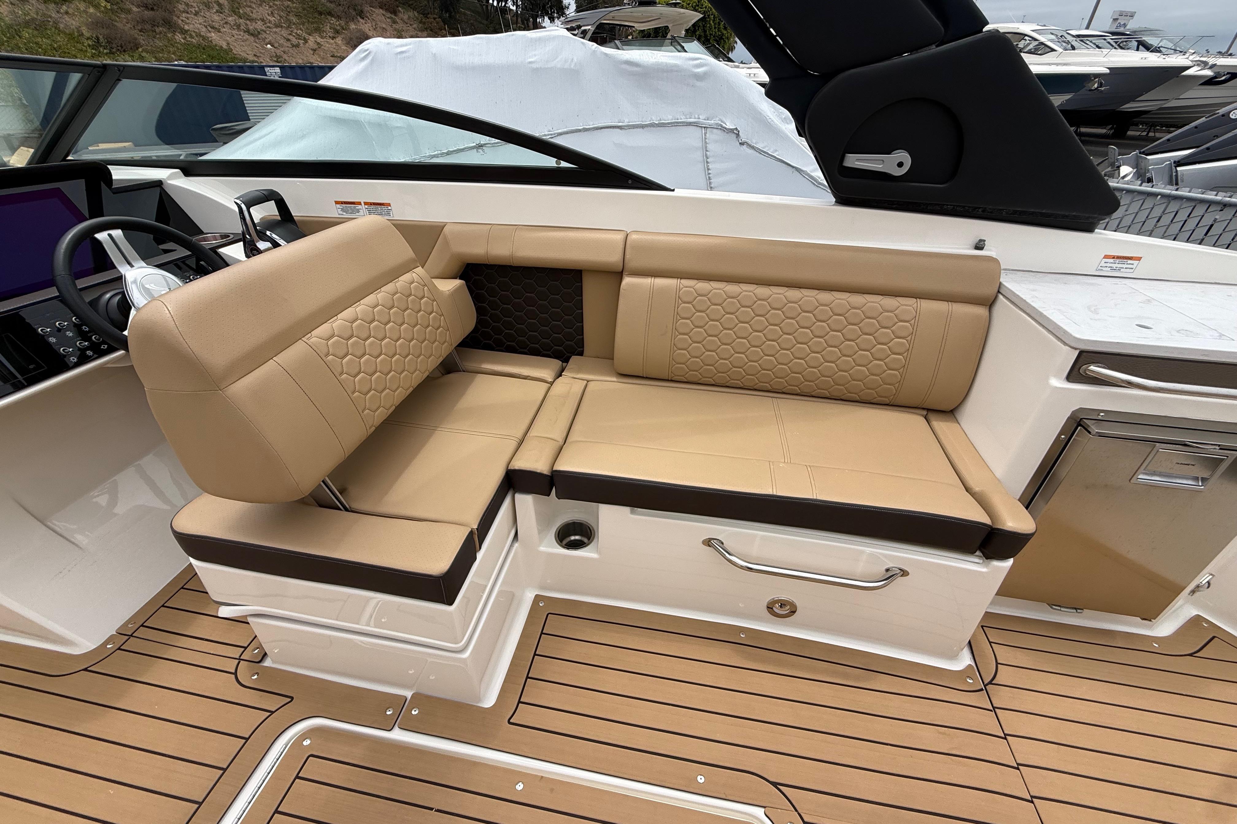 Luxurious seating on 2022 Sea Ray SDX 290 Outboard boat, featuring tan upholstery and modern design.