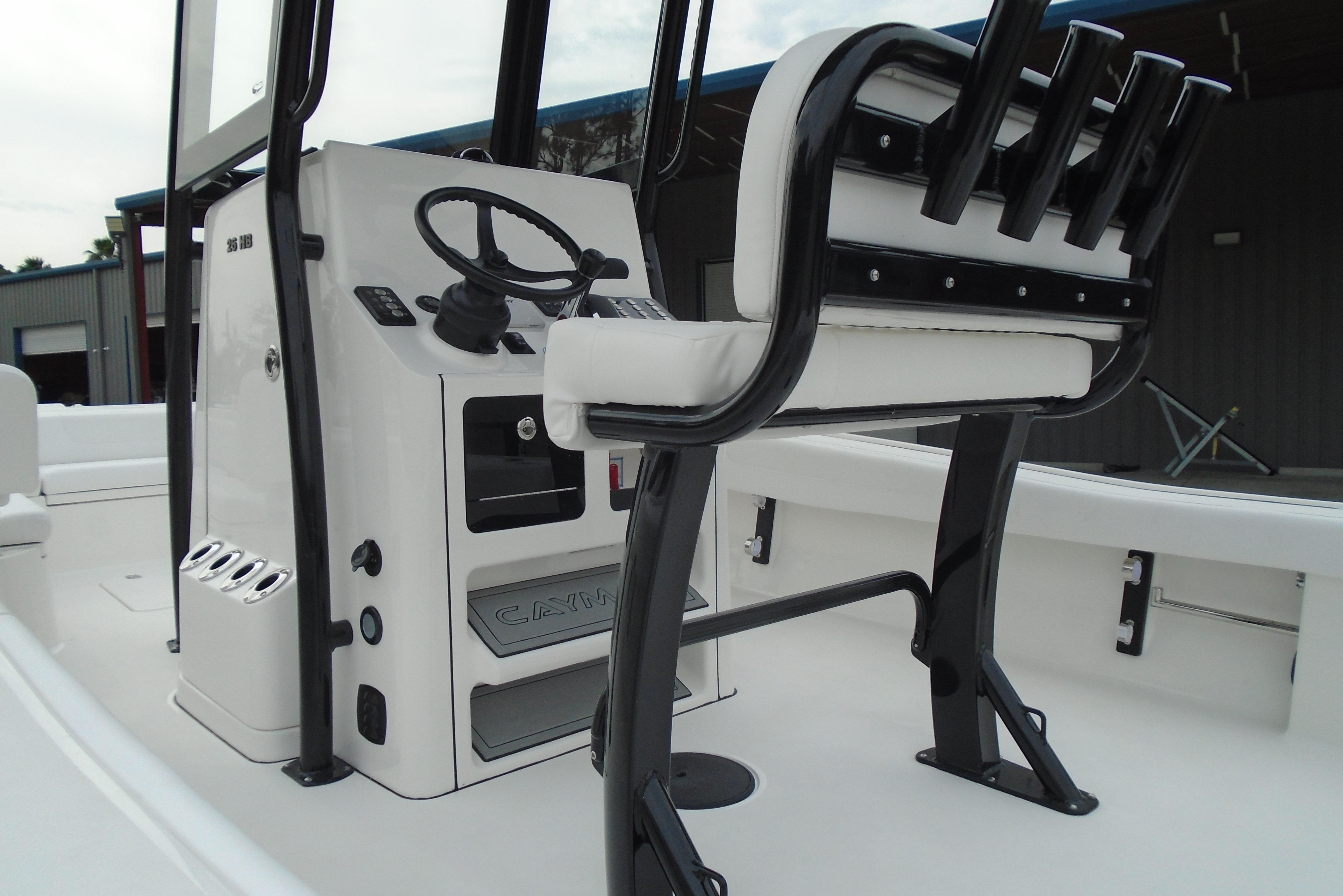 2026 Caymas 26 HB boat interior with steering console and seating.