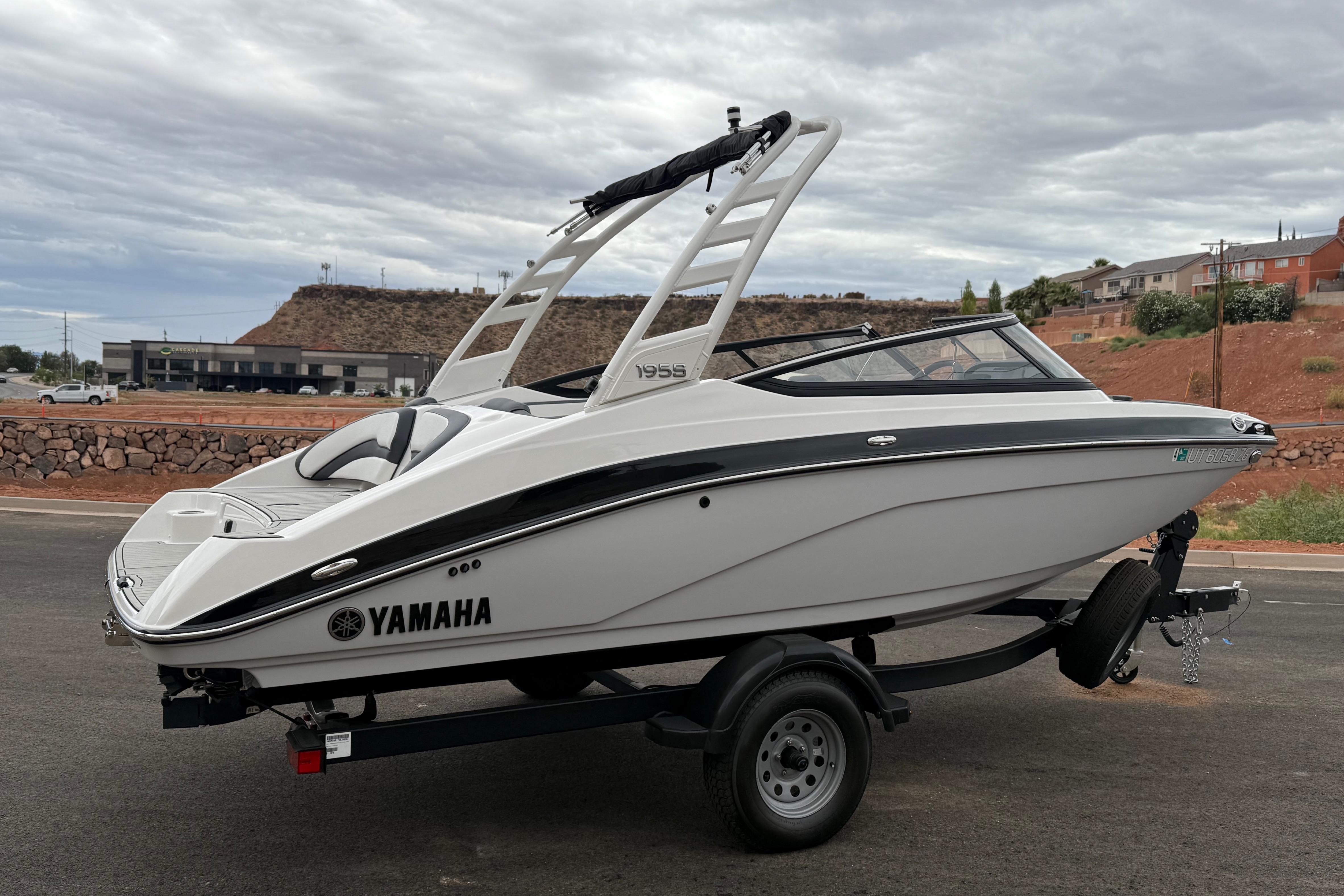2025 Yamaha Boats 195S on trailer, sleek design, parked outdoors under cloudy sky.