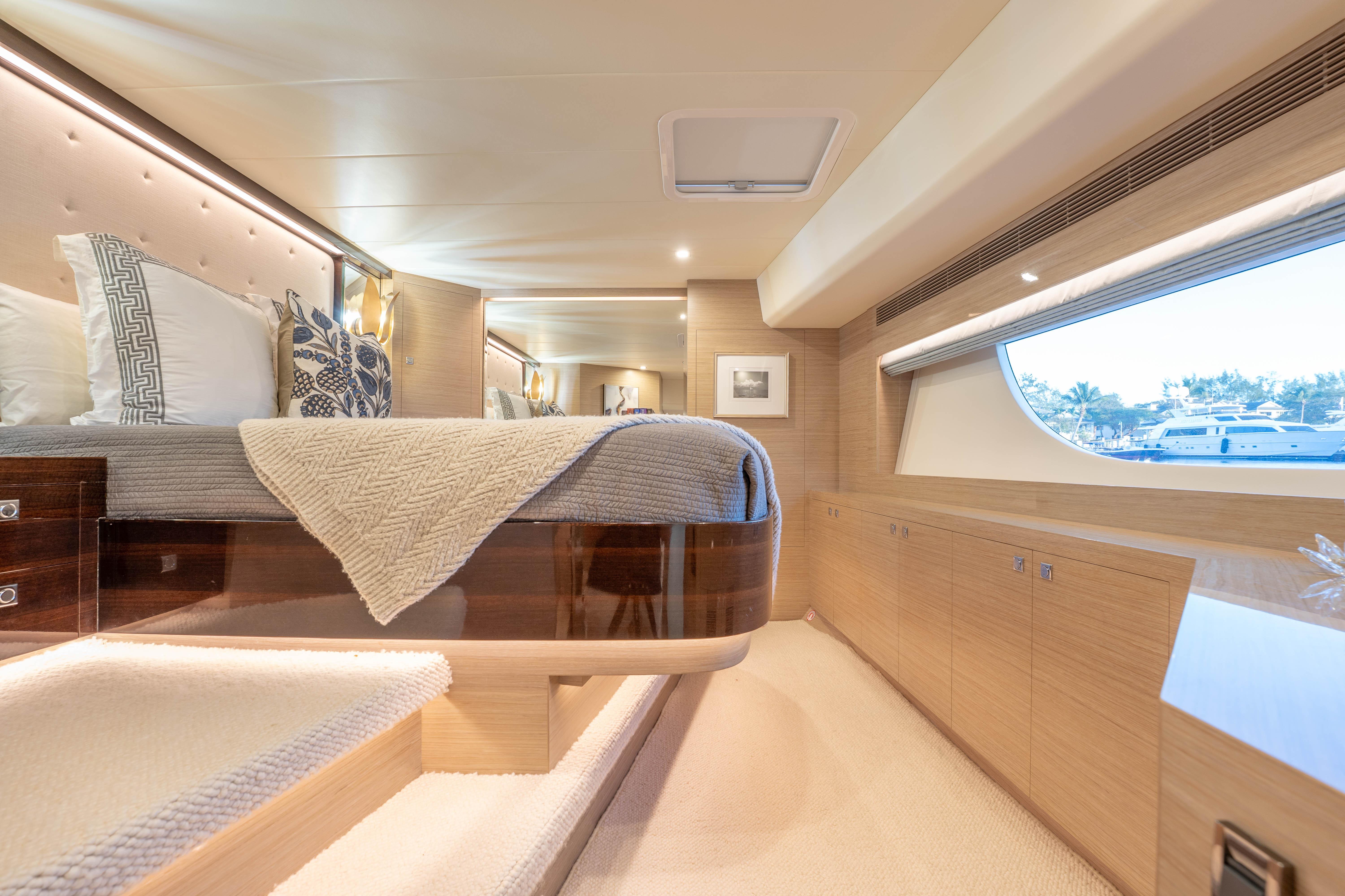 Luxurious 2021 Horizon yacht bedroom with elegant decor and large window view.