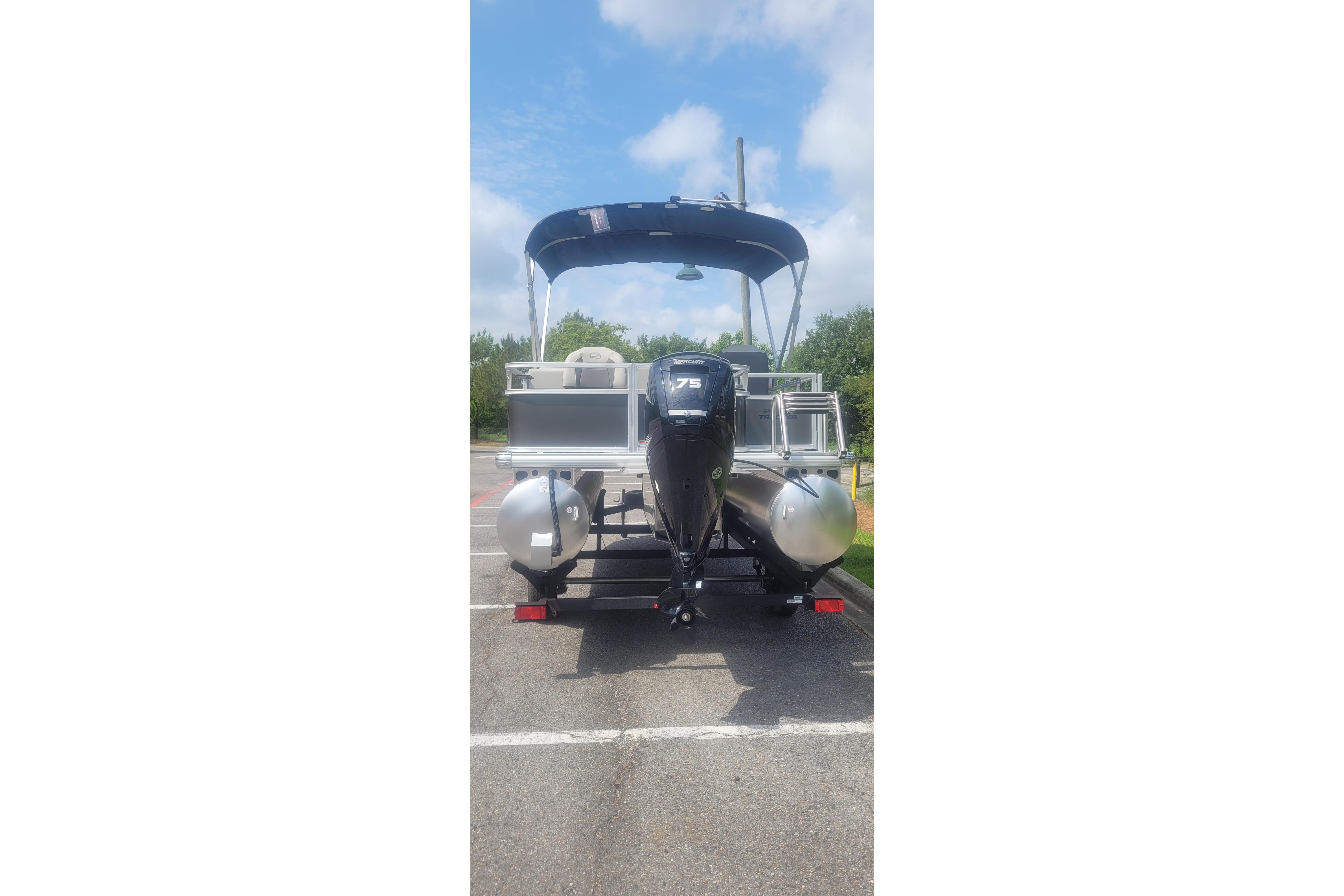 2026 Sun Tracker Bass Buggy 18 DLX pontoon boat with canopy and outboard motor.